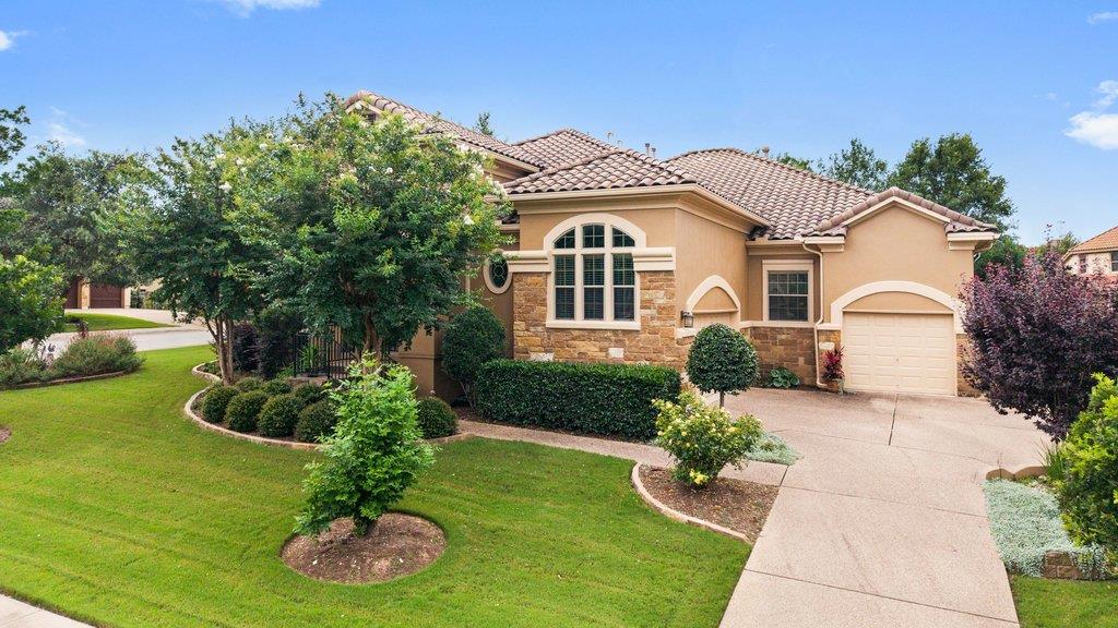 A well-maintained stucco and stone facade home fe
