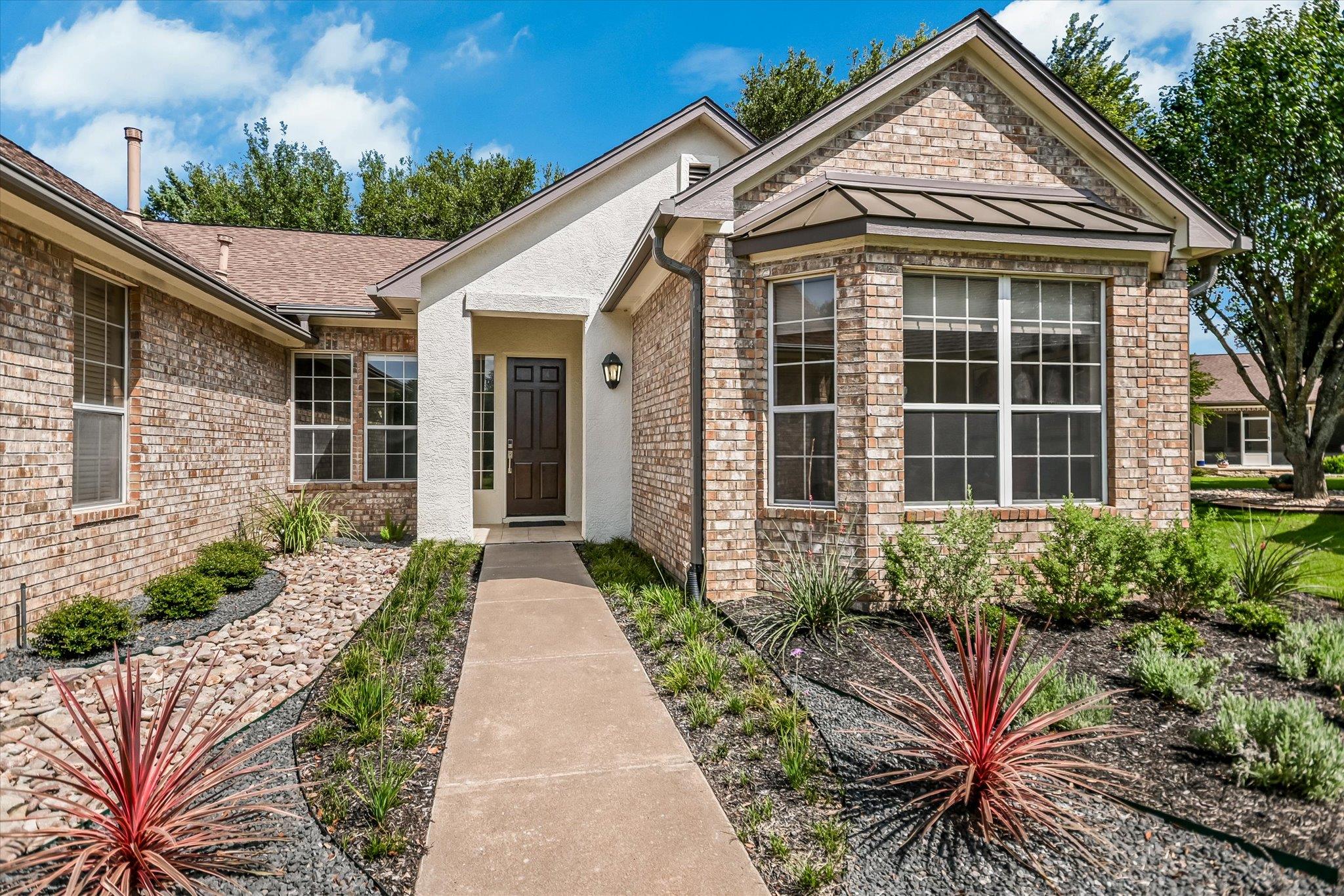 A well-kept front yard with mature landscaping an