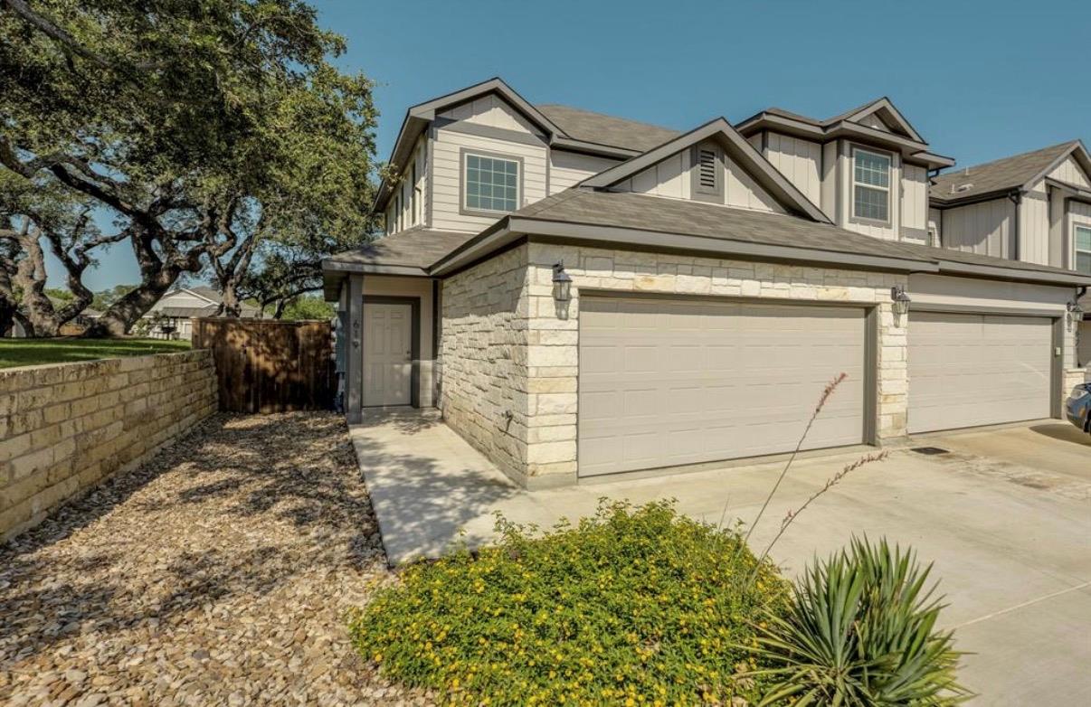 Limestone masonry accents and a multi-car garage 