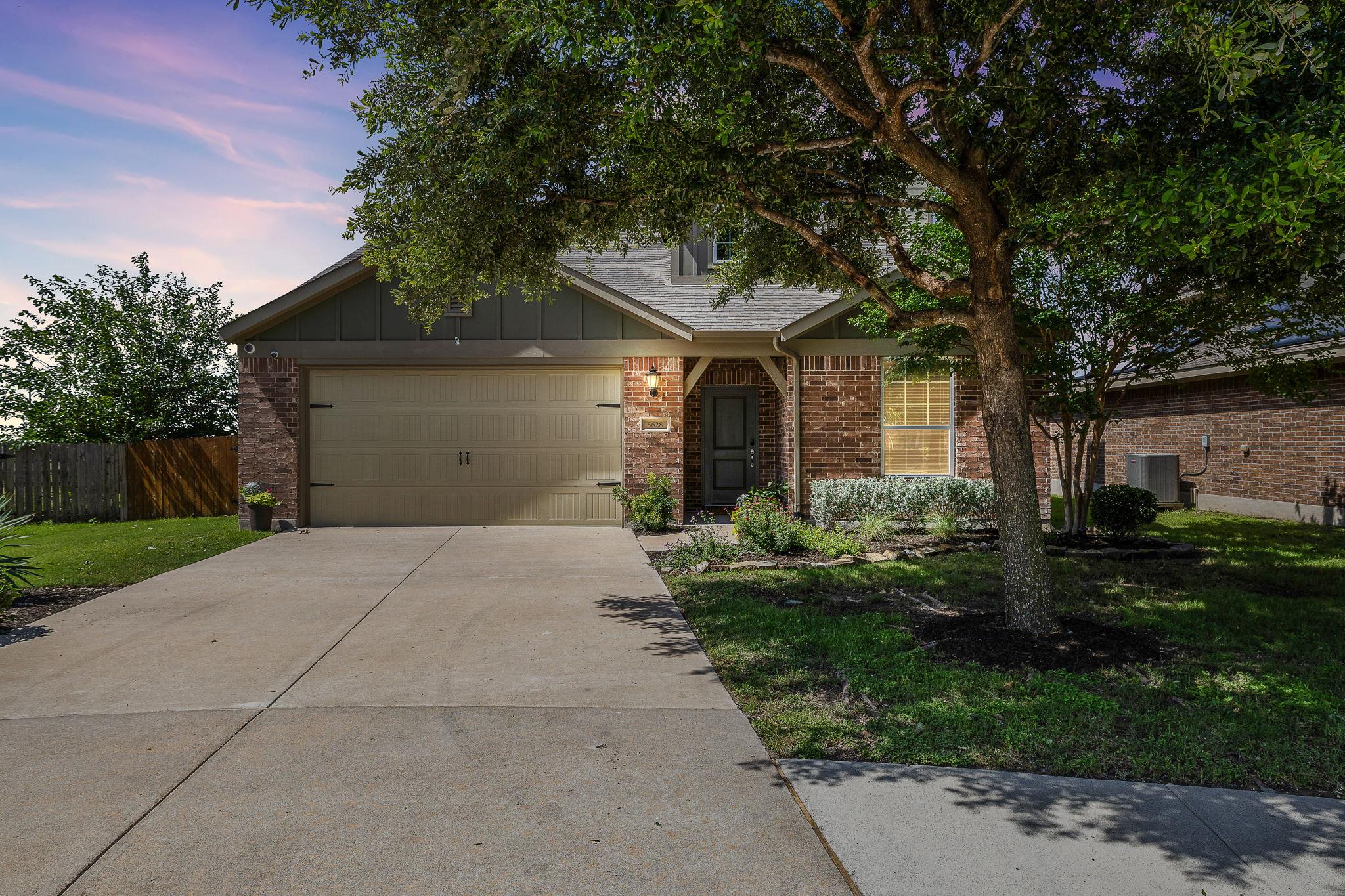 Brick facade and manicured landscaping enhance th