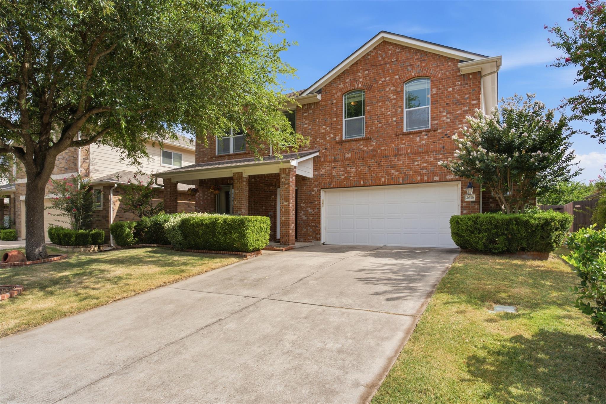 A classic brick facade welcomes you home, framed 