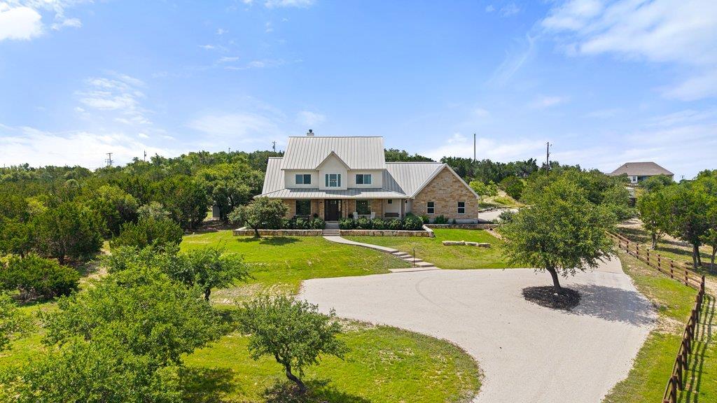 A spacious home with stone accents and a metal ro