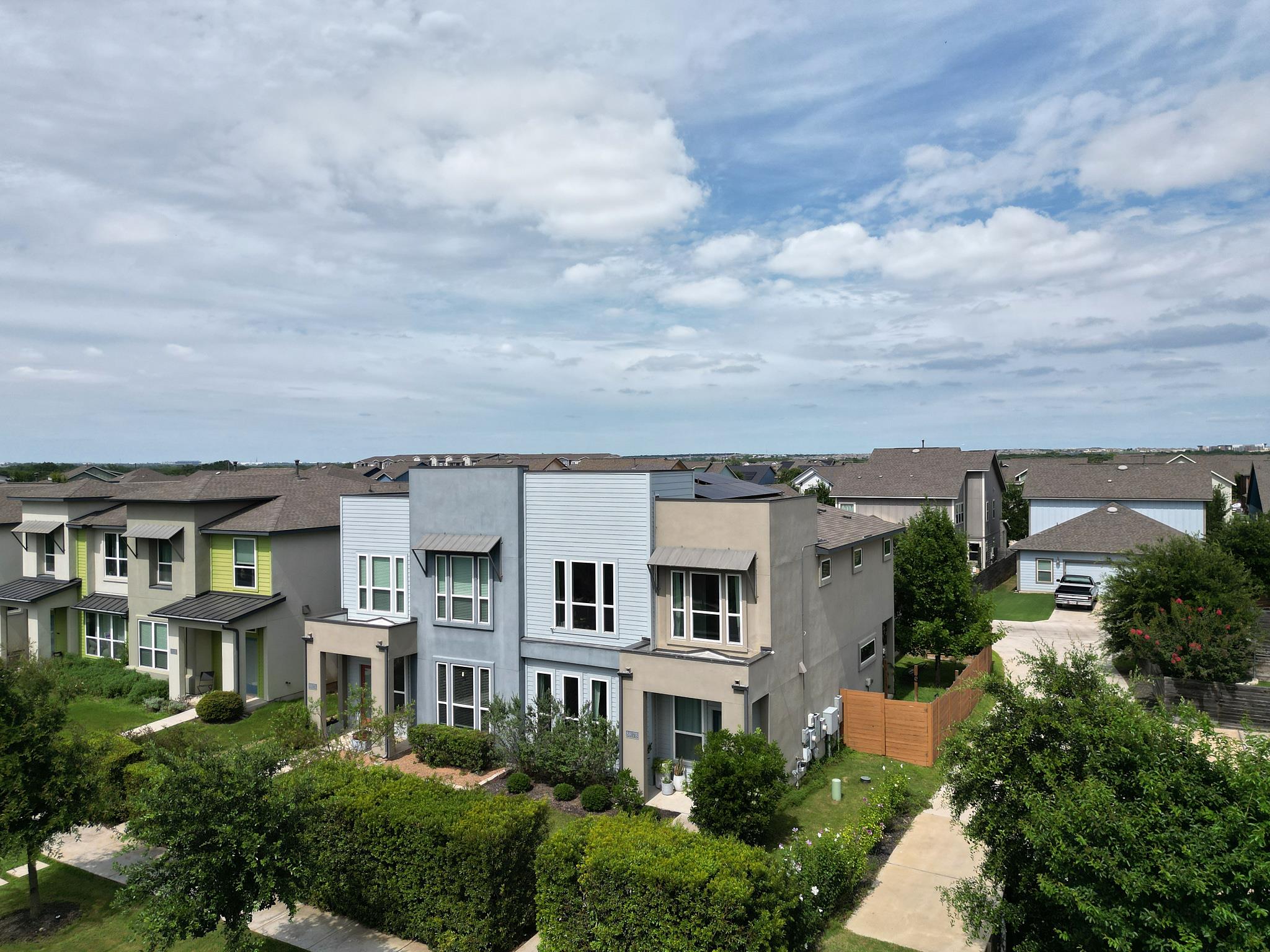 Contemporary facades and lush landscaping define 