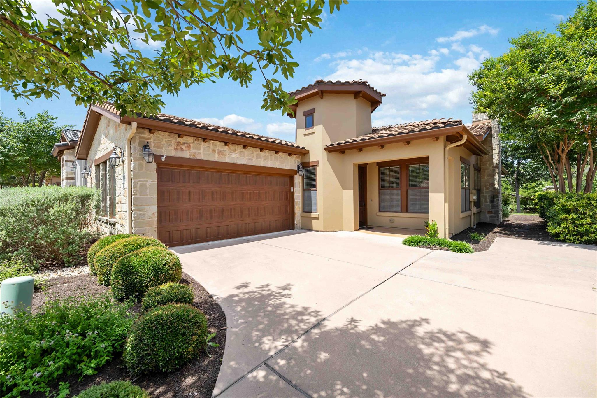 A charming stucco and stone exterior home boasts 