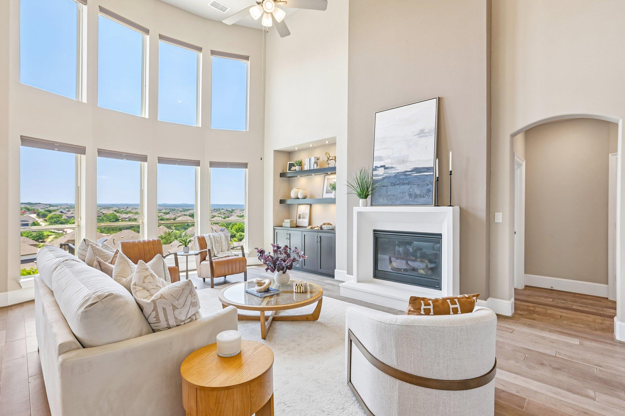 Dramatic two-story windows frame a captivating lo
