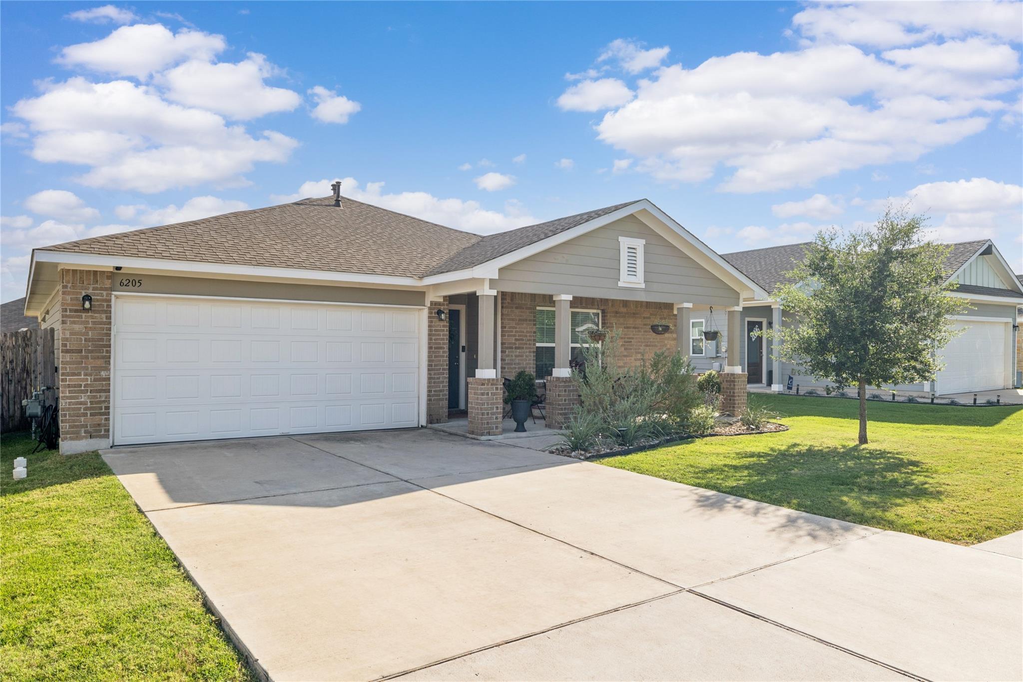 A welcoming front porch, mature landscaping, and 