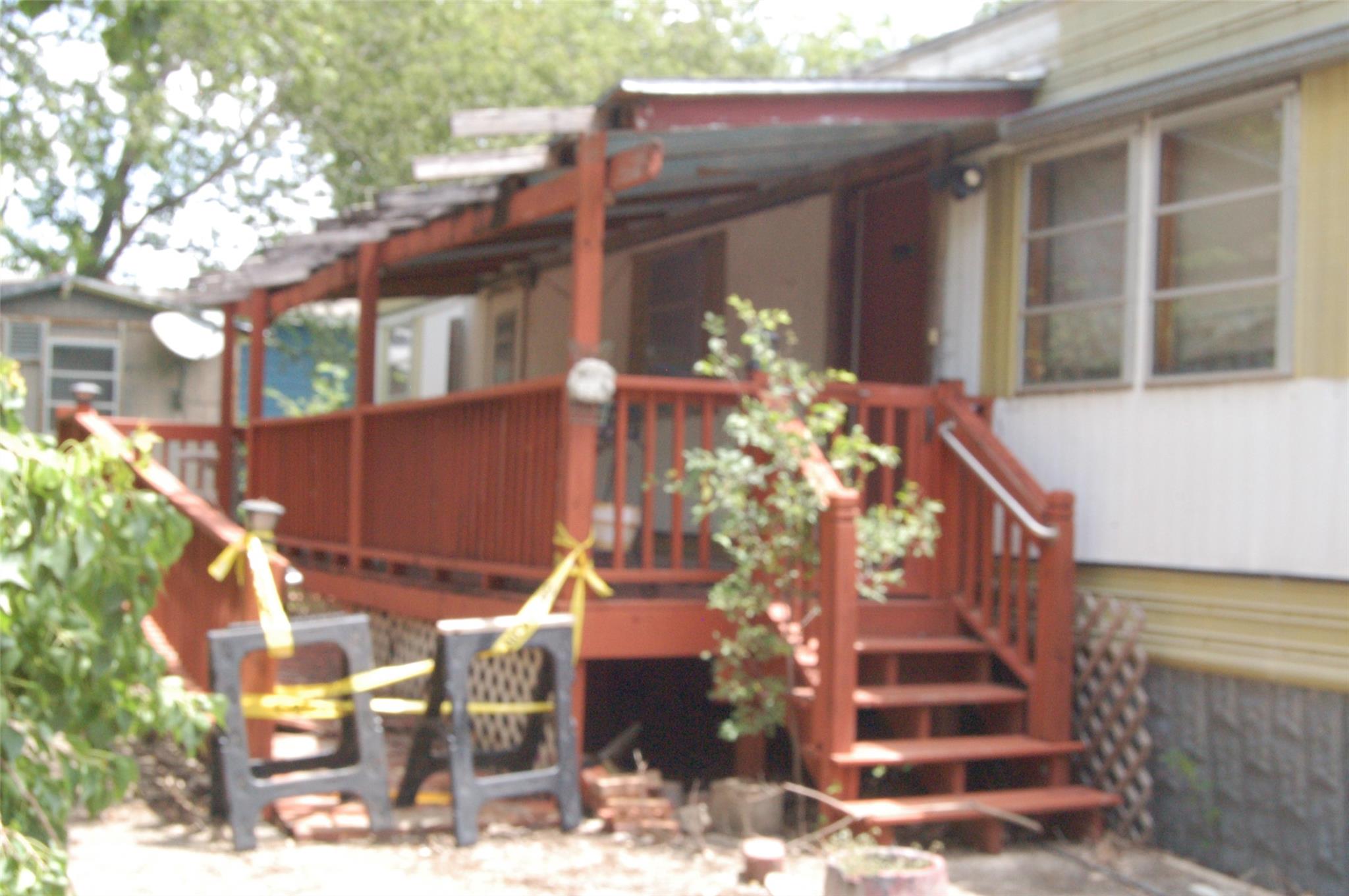A welcoming front porch, shaded by a sturdy overh