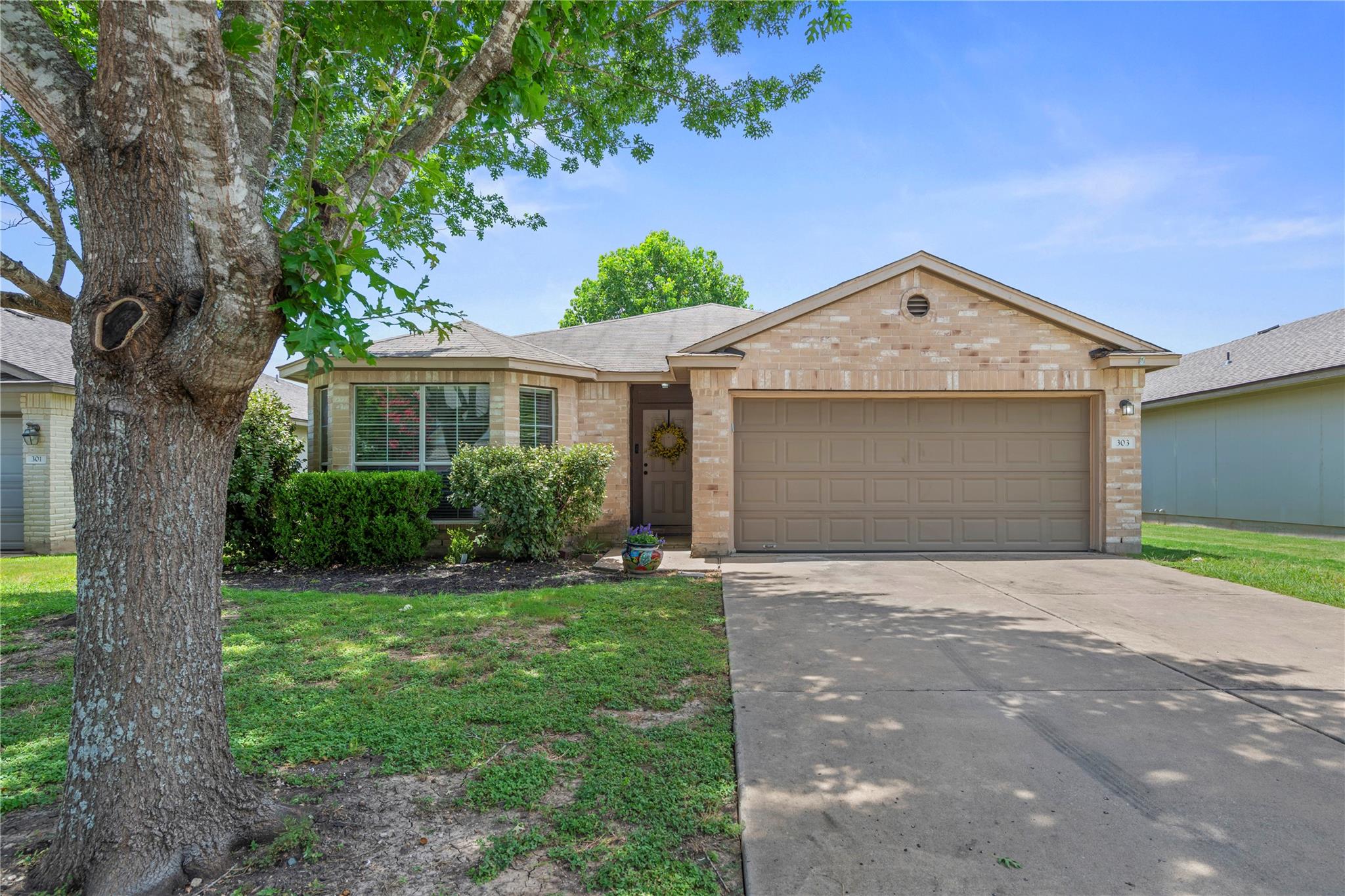 A classic brick exterior with a two-car garage pr