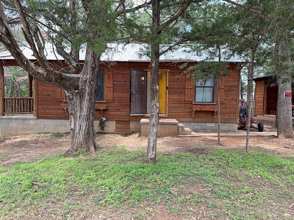 A charming wooden cabin nestled among mature tree