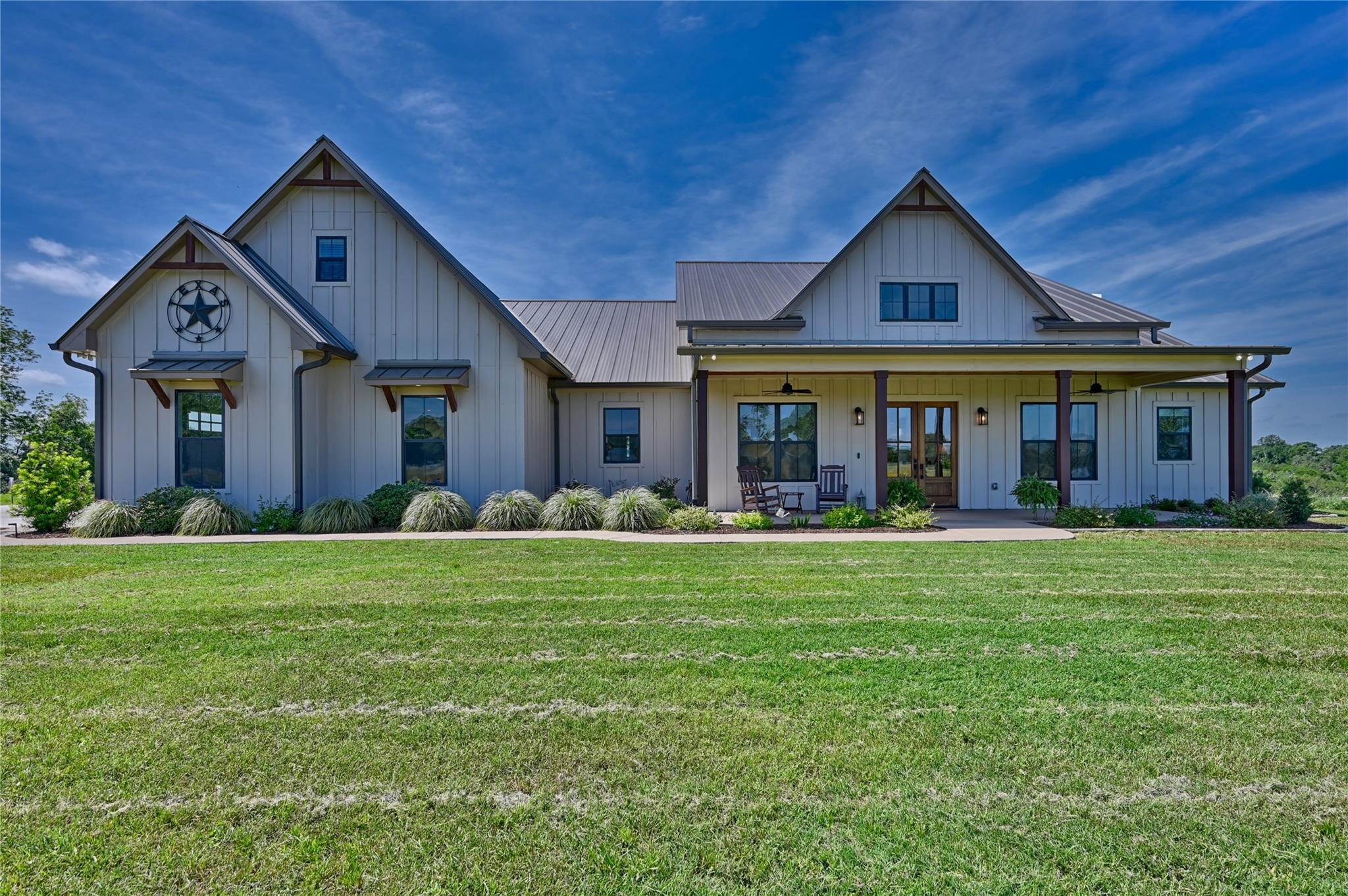 A spacious front yard complements this farmhouse-