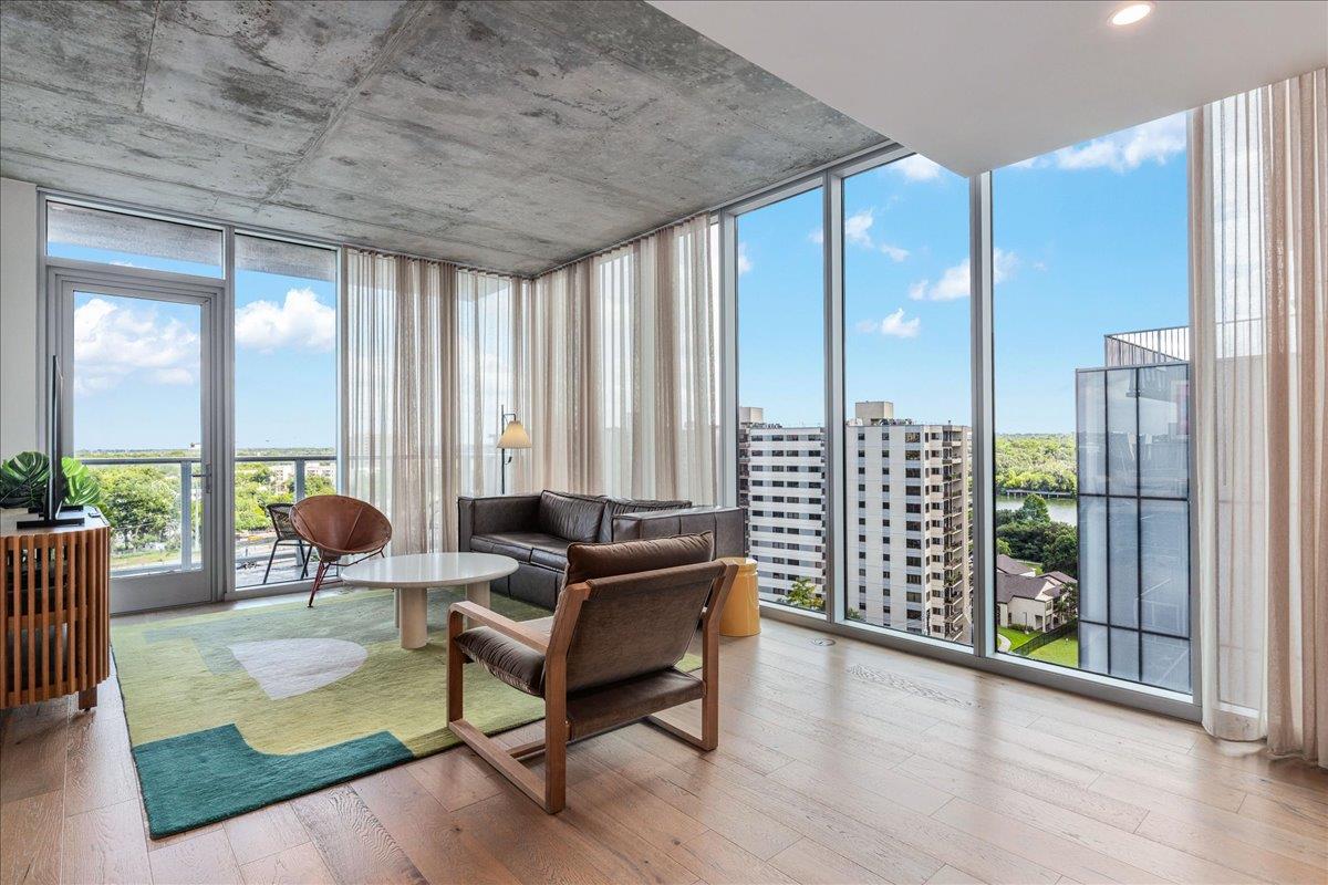 Floor-to-ceiling windows present a panoramic city