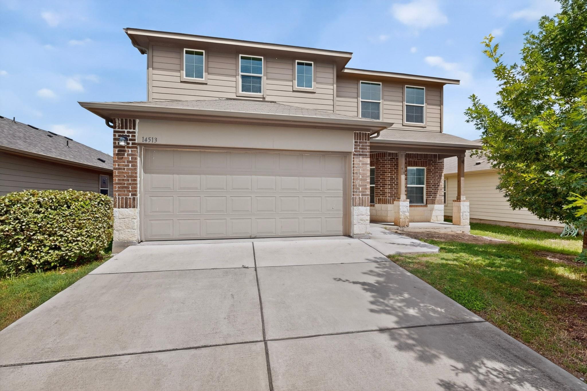 A welcoming facade with a neutral-toned garage do