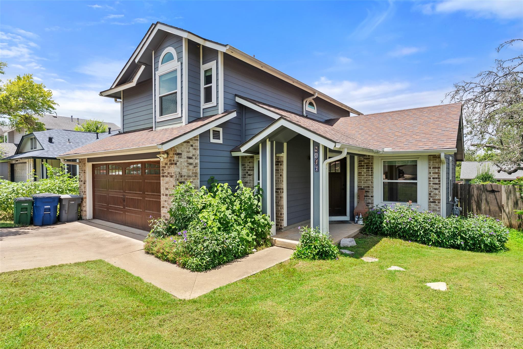 A welcoming facade showcases durable siding, bric