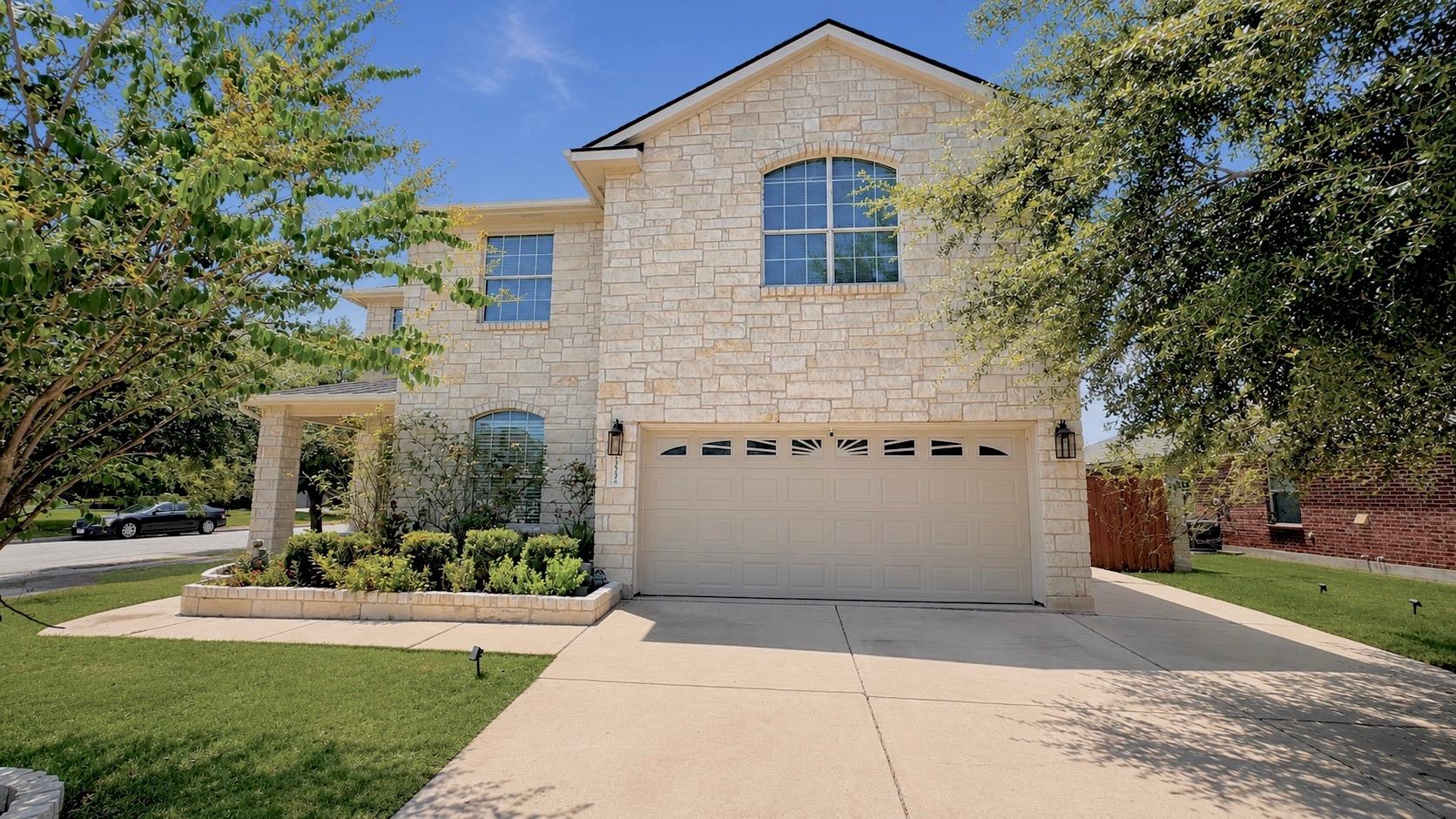 Textured light-colored stone masonry defines the 