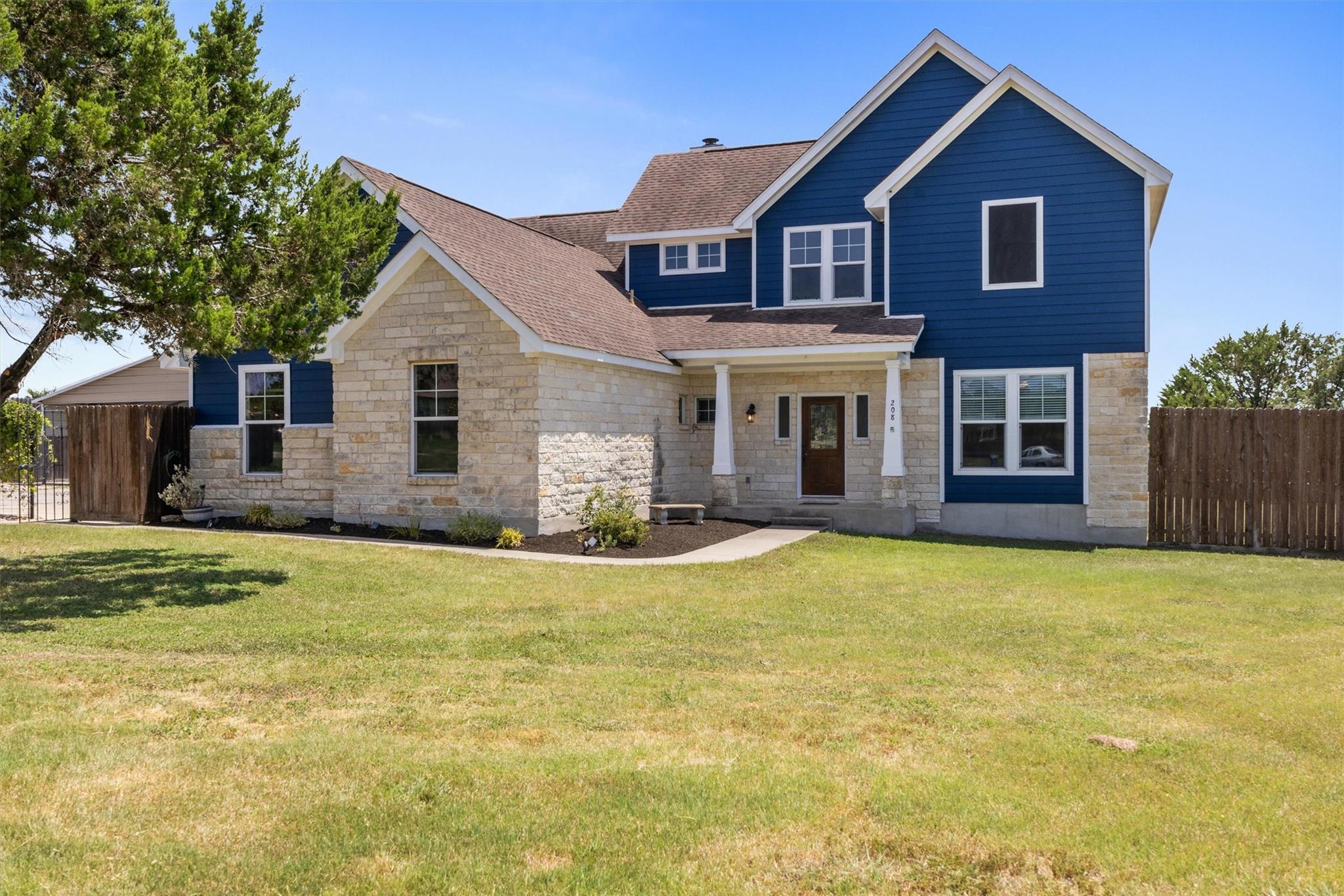 A welcoming stone and siding facade offers classi