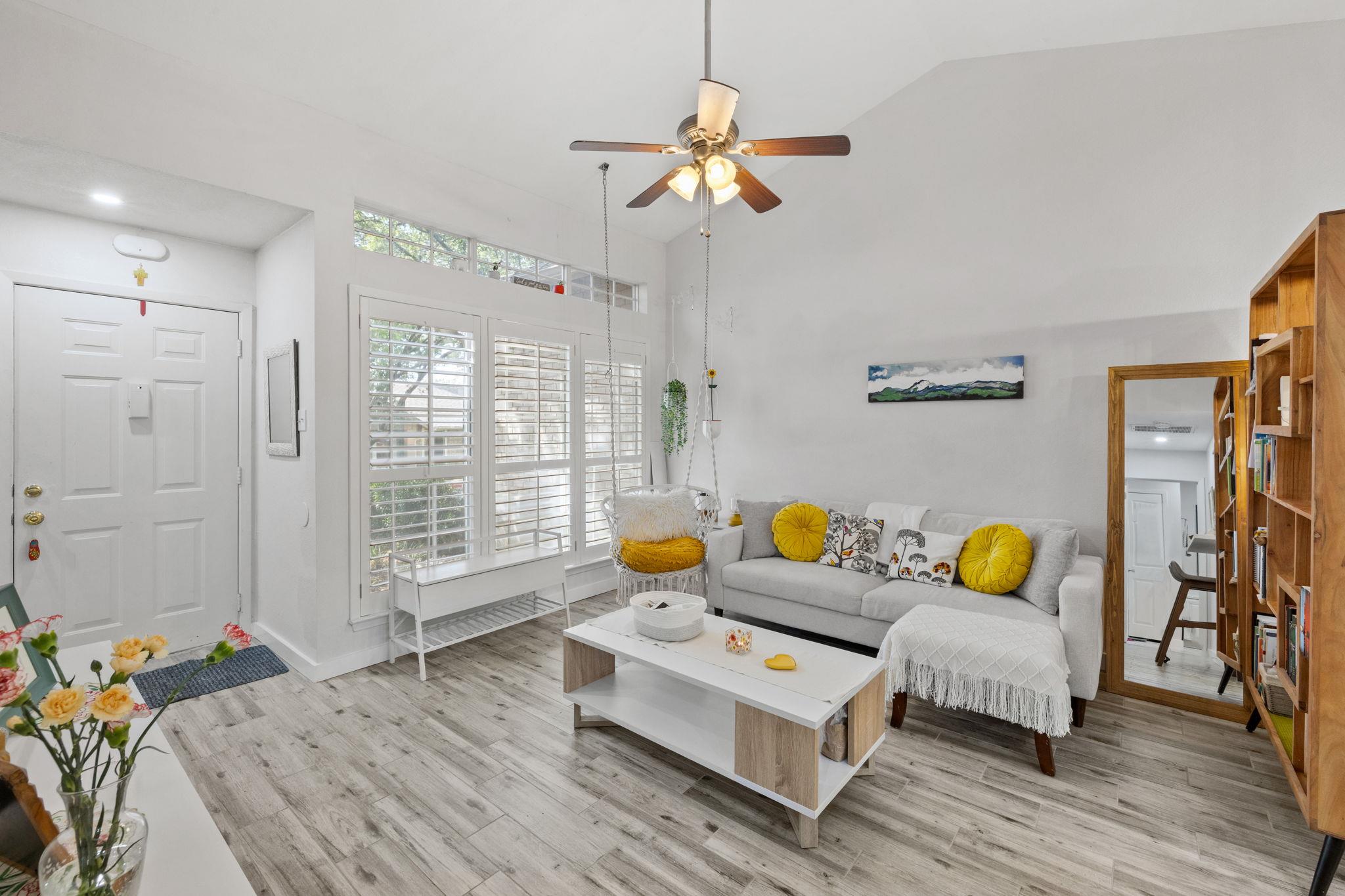 Step into a sun-filled living space with vaulted 