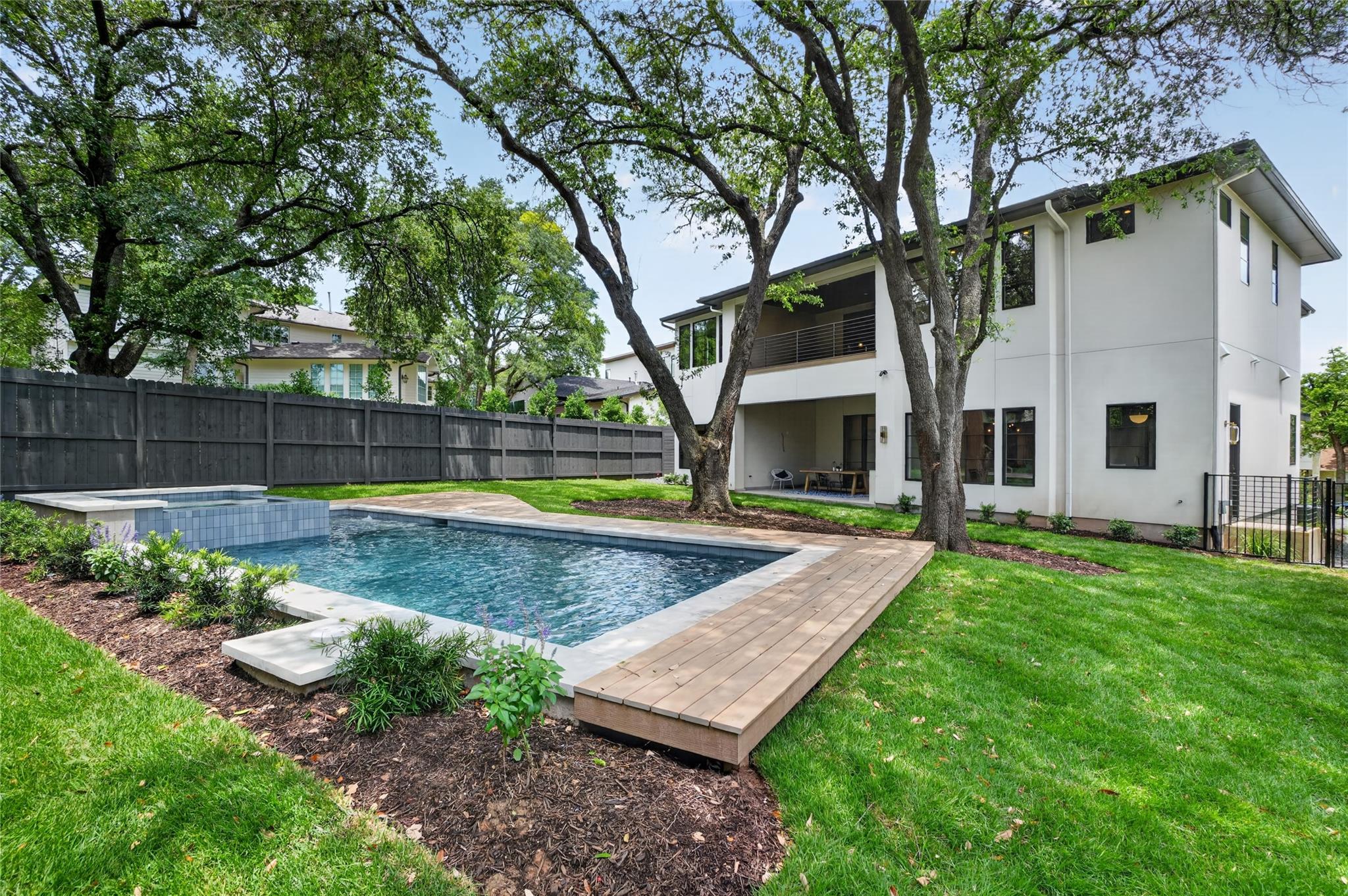 An inviting pool with a relaxing spa offers the p