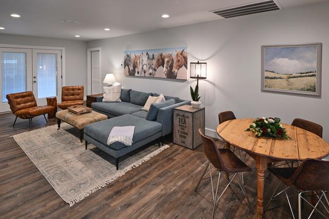 Natural wood flooring complements the bright, ope