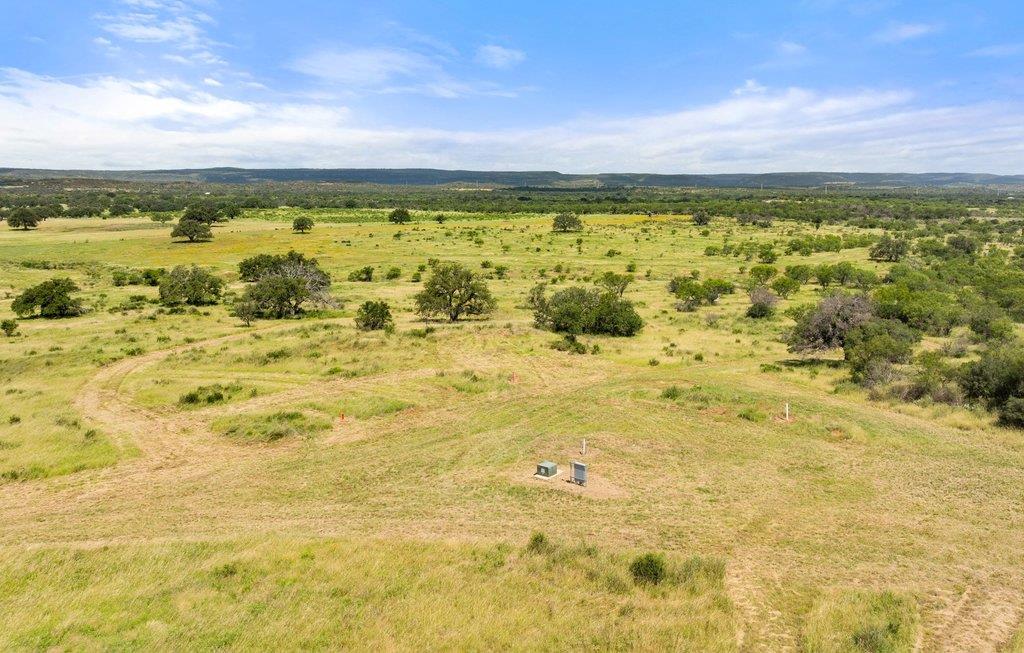 Vast, open pastureland under an azure sky, dotted