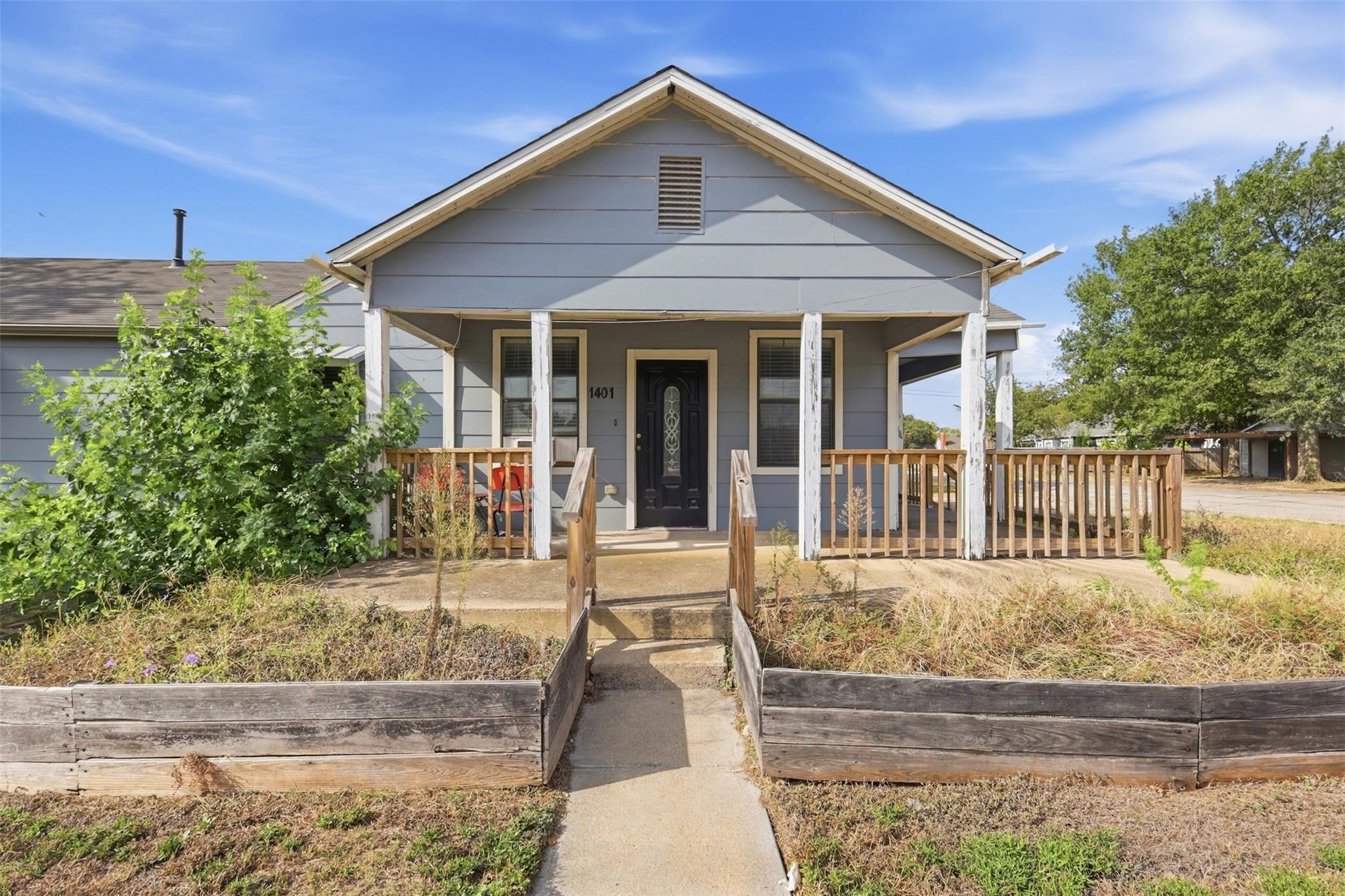 A welcoming front porch with wooden railings lead