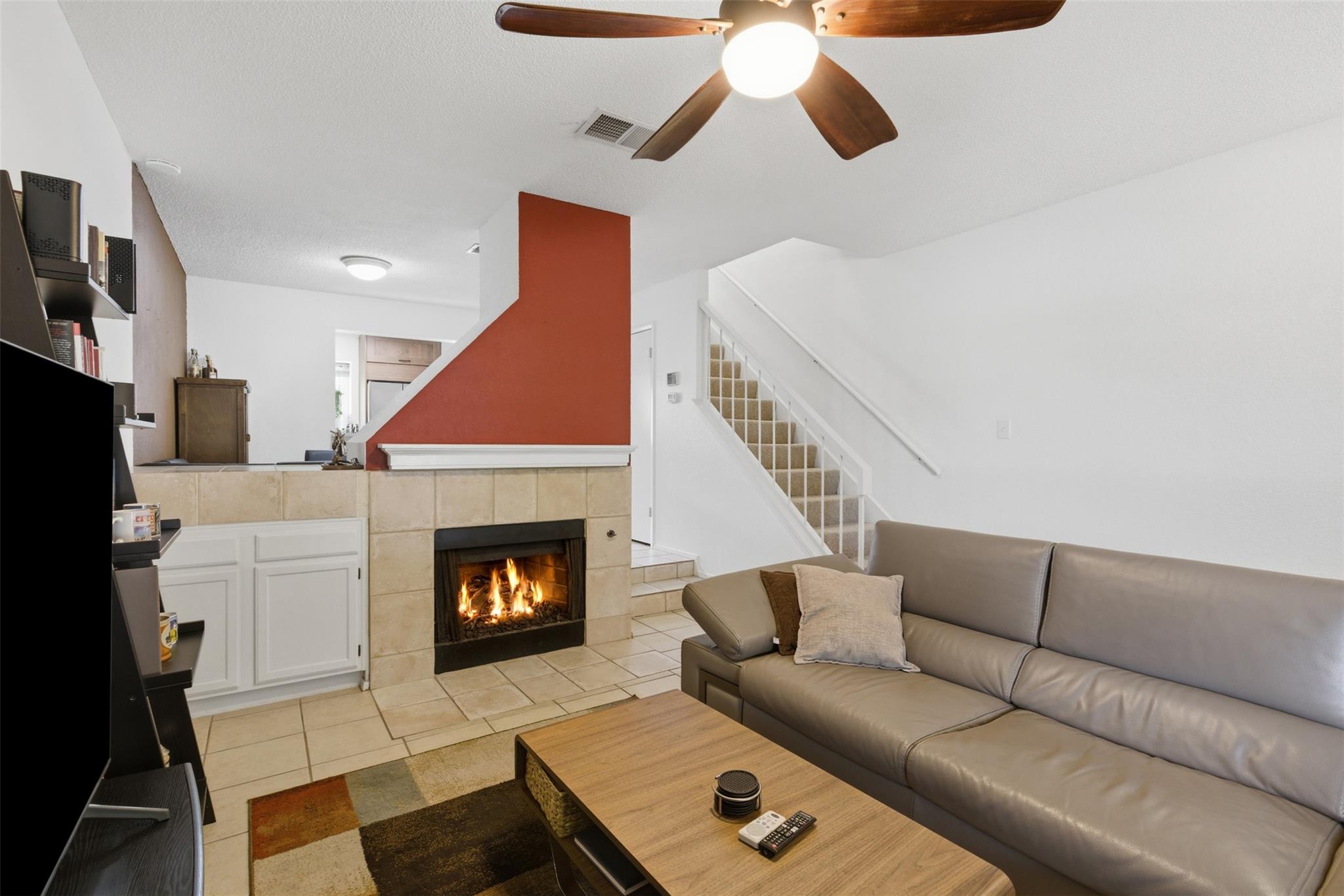 A cozy living space features a corner fireplace w