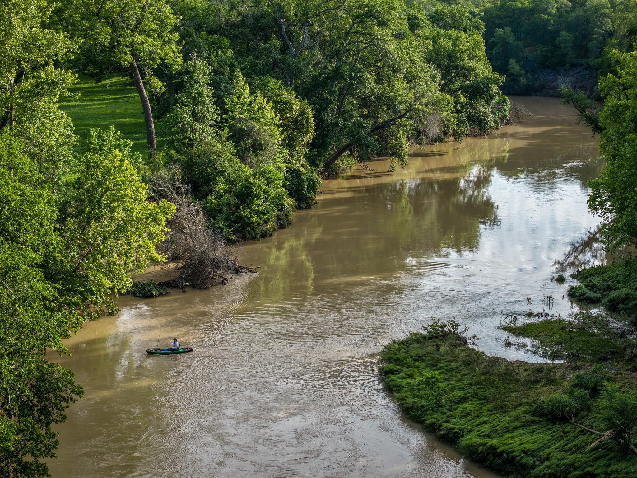 A tranquil river meanders through verdant woods, 