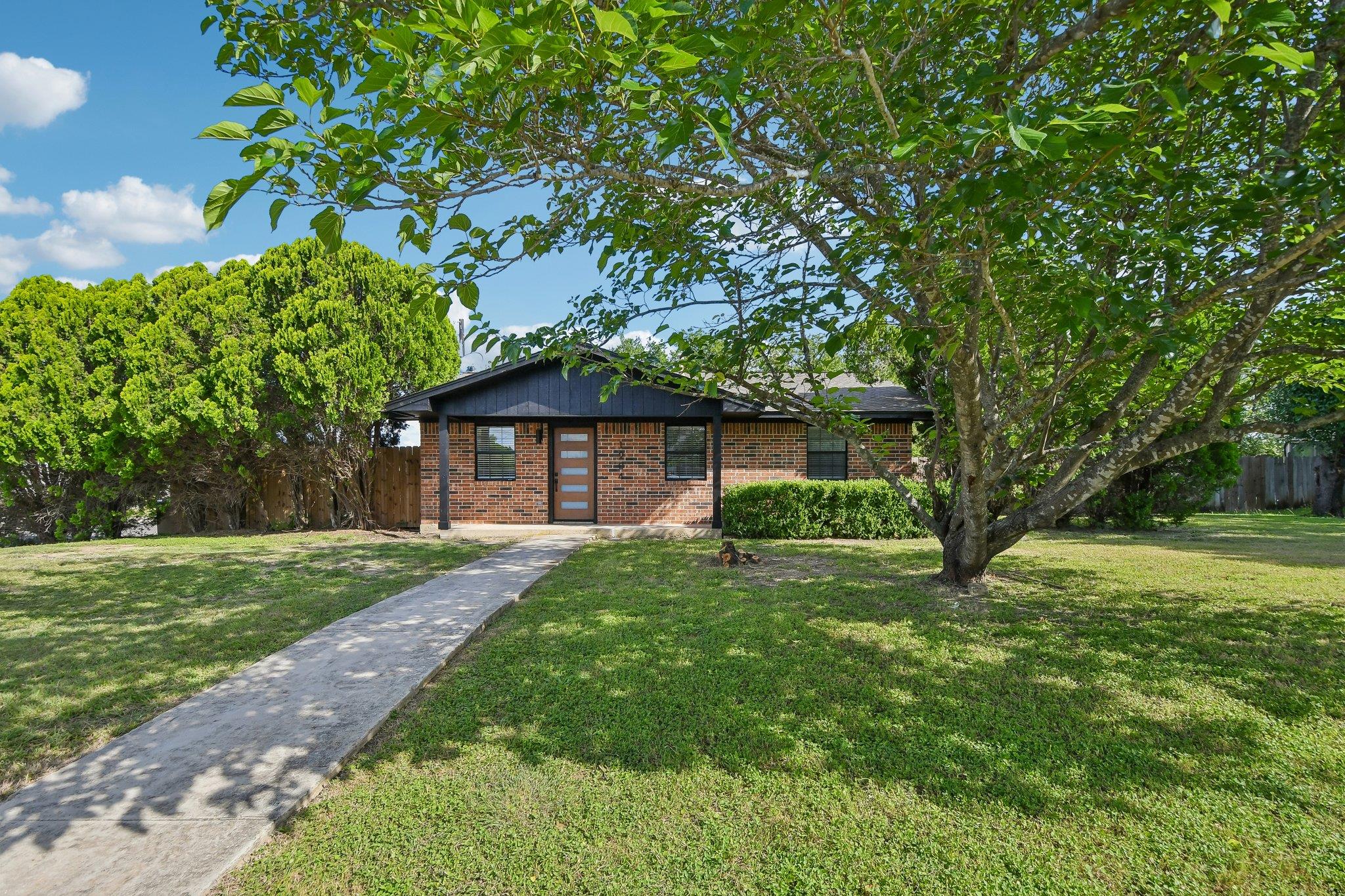 A classic brick exterior welcomes with ample fron