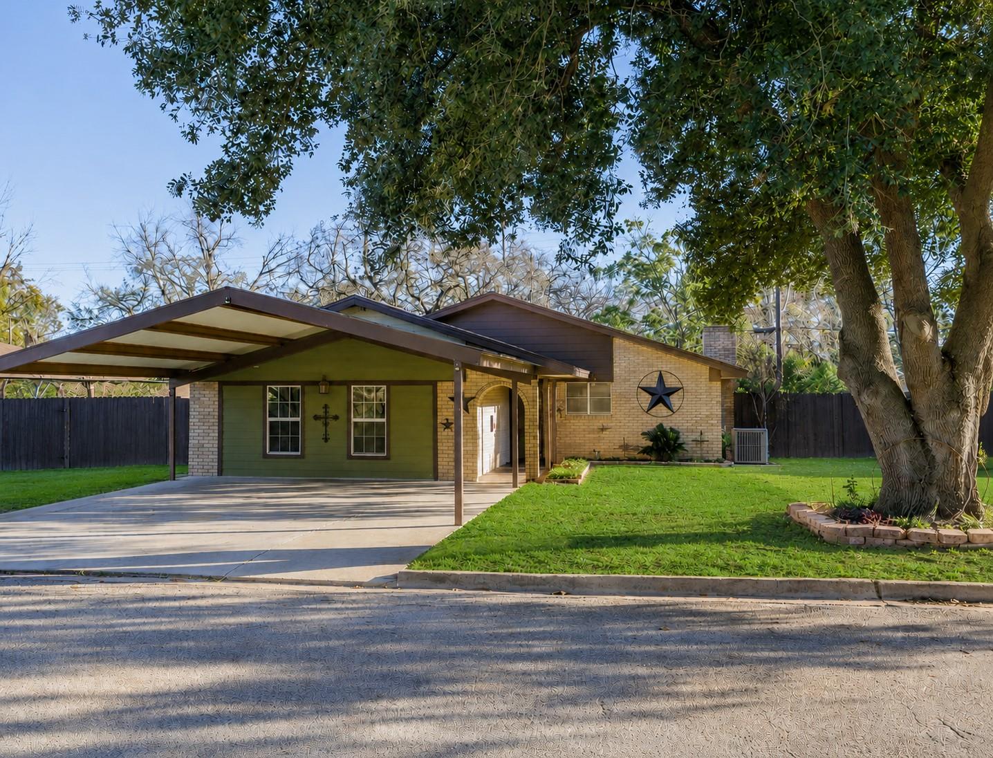 A welcoming brick and siding home features a spac