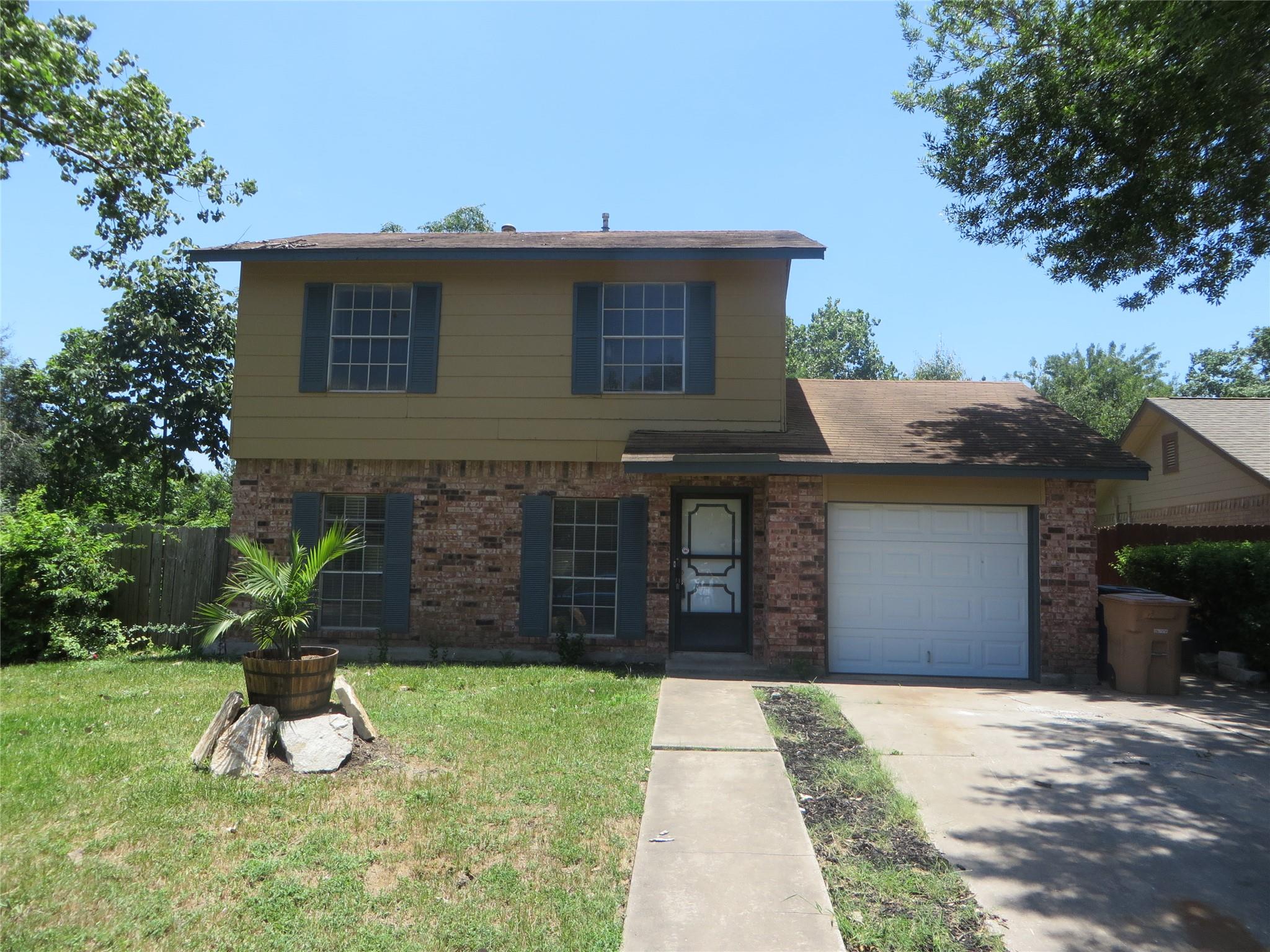 A charming brick and siding facade welcomes you, 