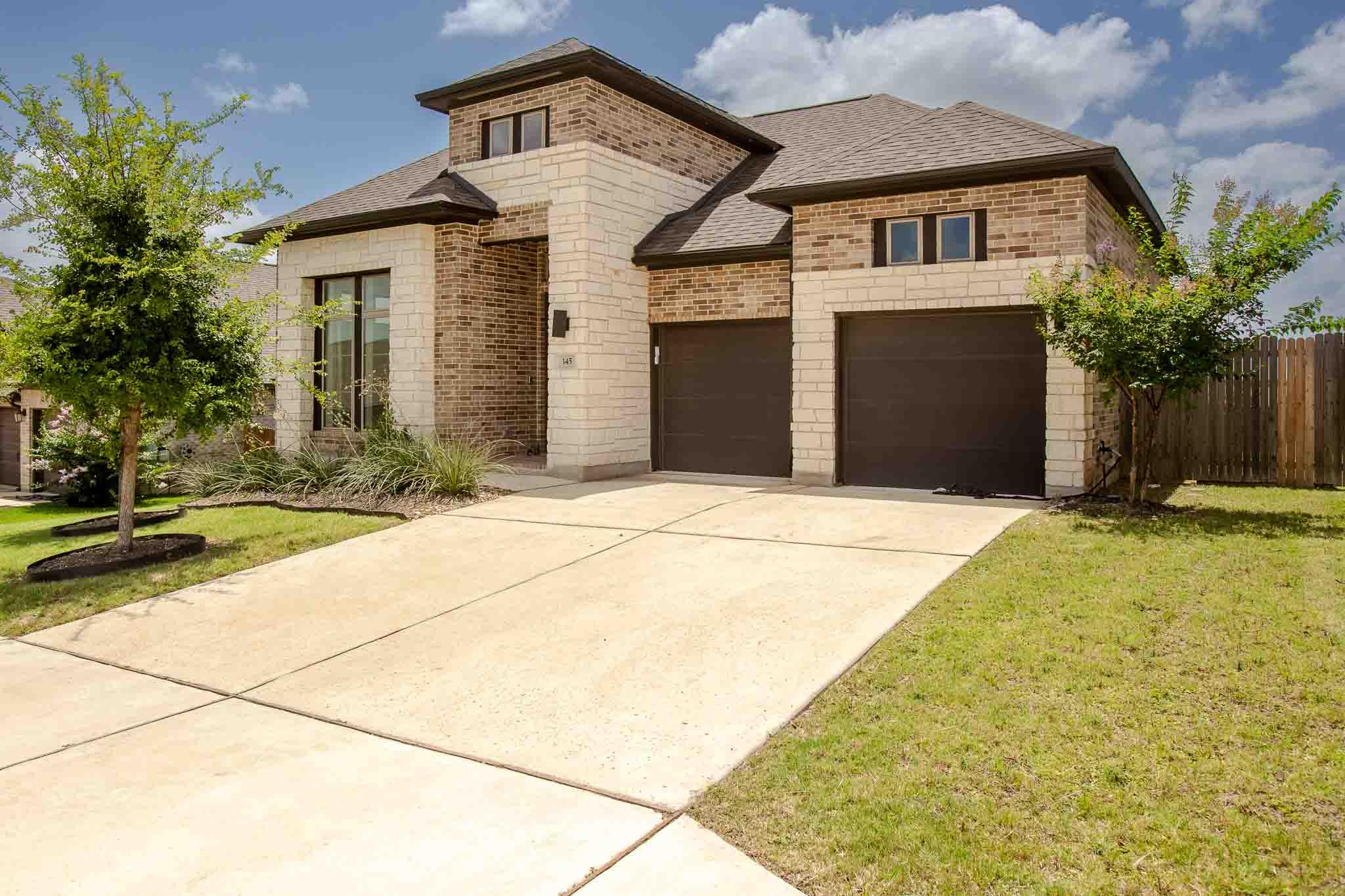 A striking exterior combines brick and stone, sho