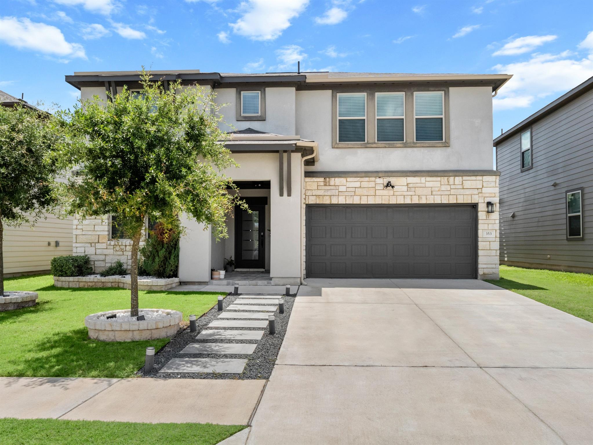 A contemporary exterior blends stucco and stone, 