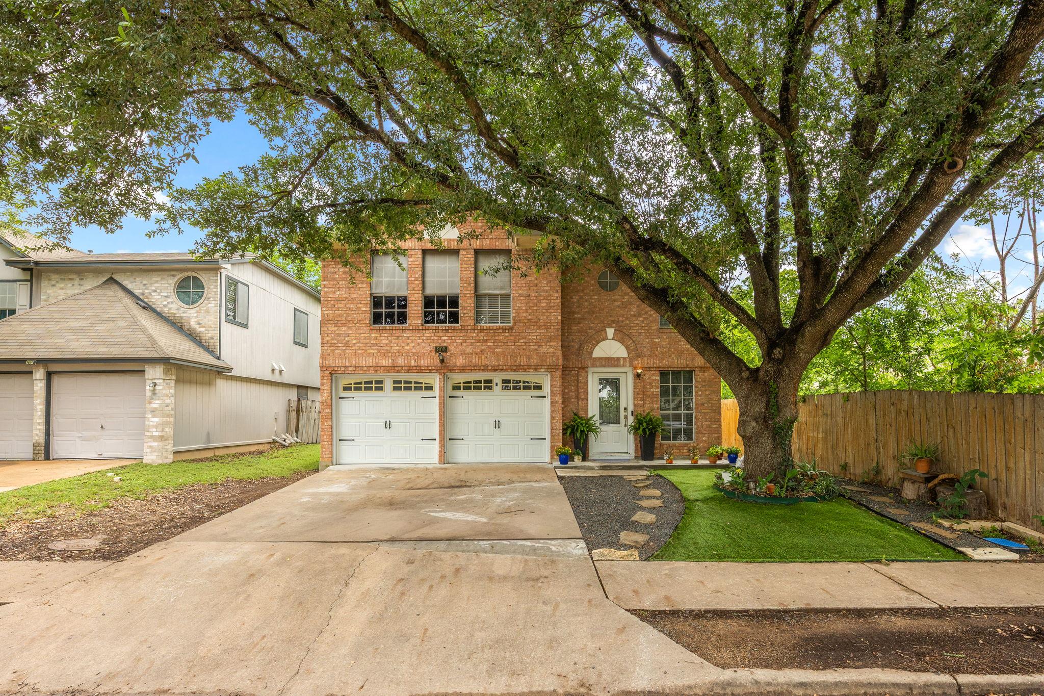An inviting brick facade with a two-car garage is