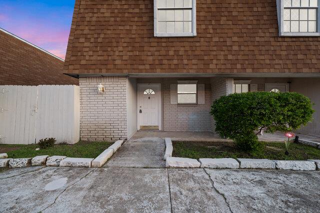 A classic brick and shingle facade offers charmin