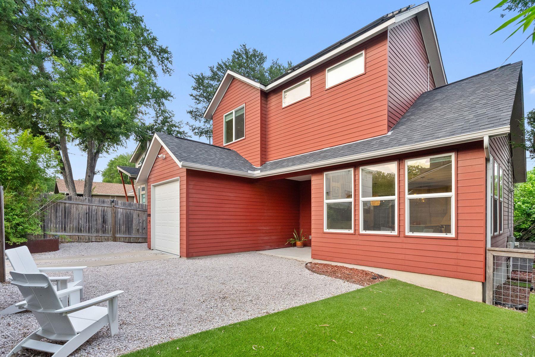 Bold red siding distinguishes this unique home wi
