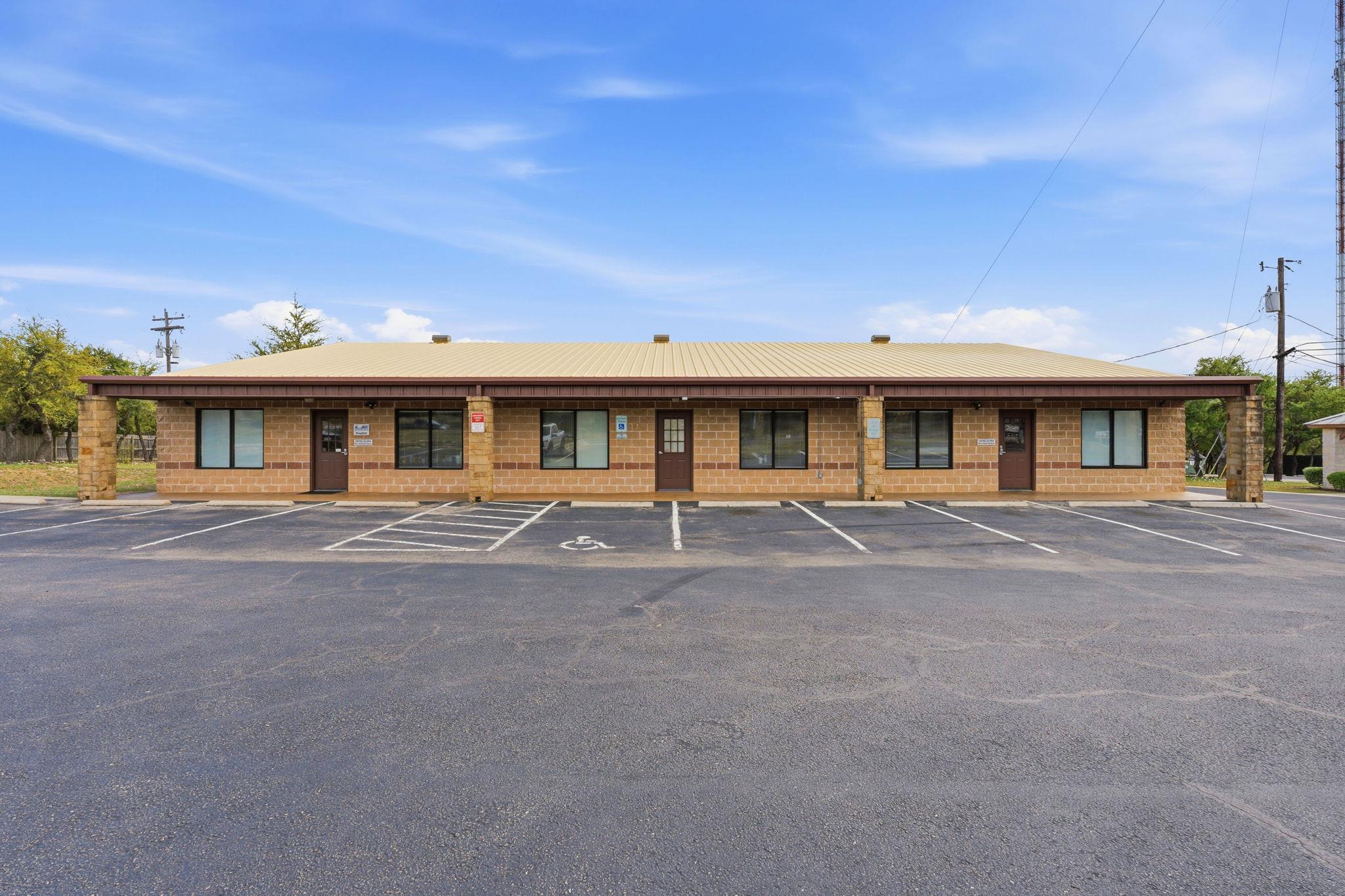 A commercial property featuring a metal roof, bri