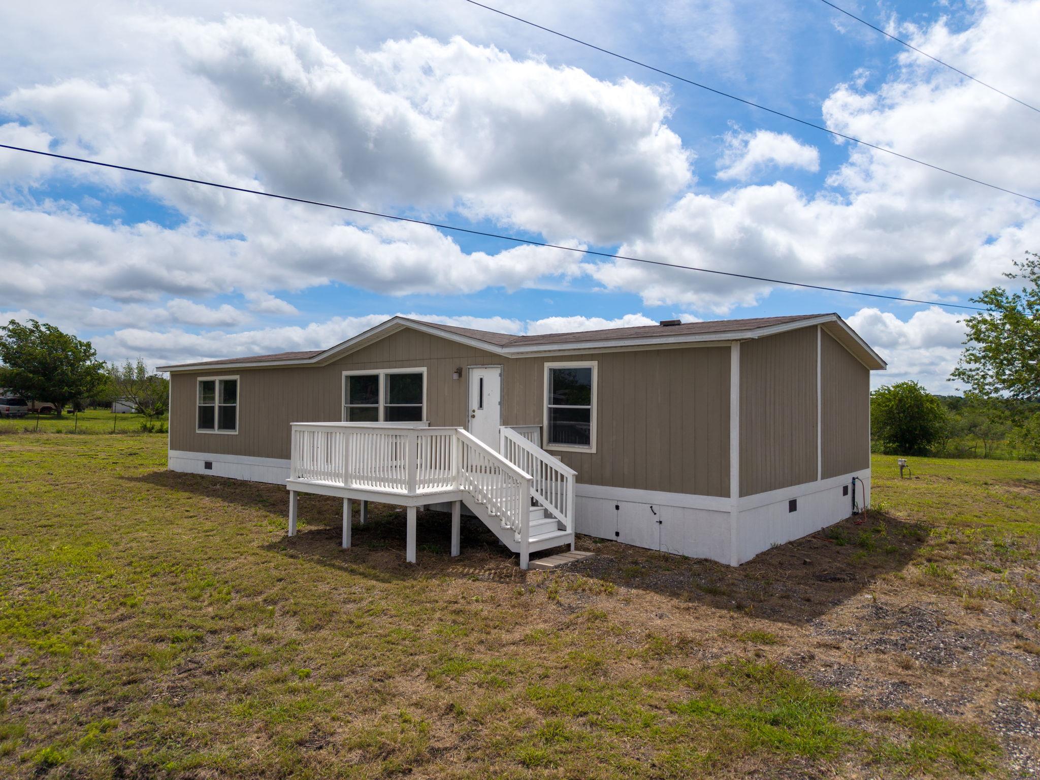A well-maintained manufactured home sits atop a v