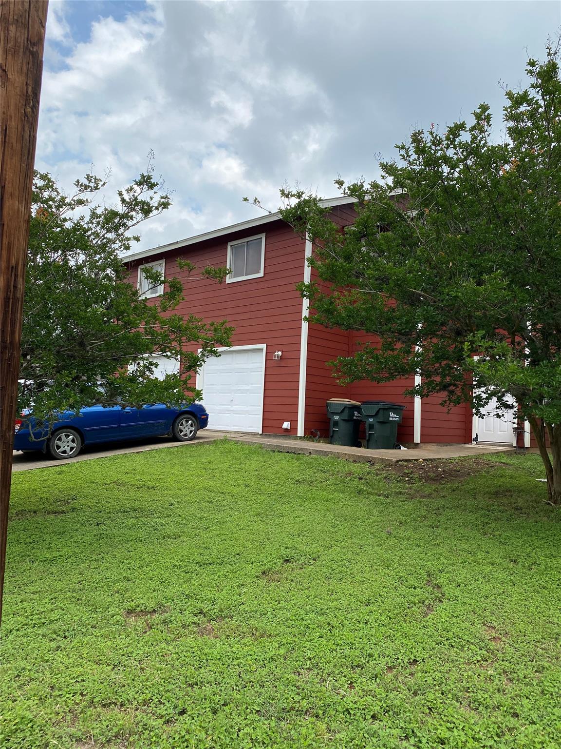 A well-maintained facade with ample green space a
