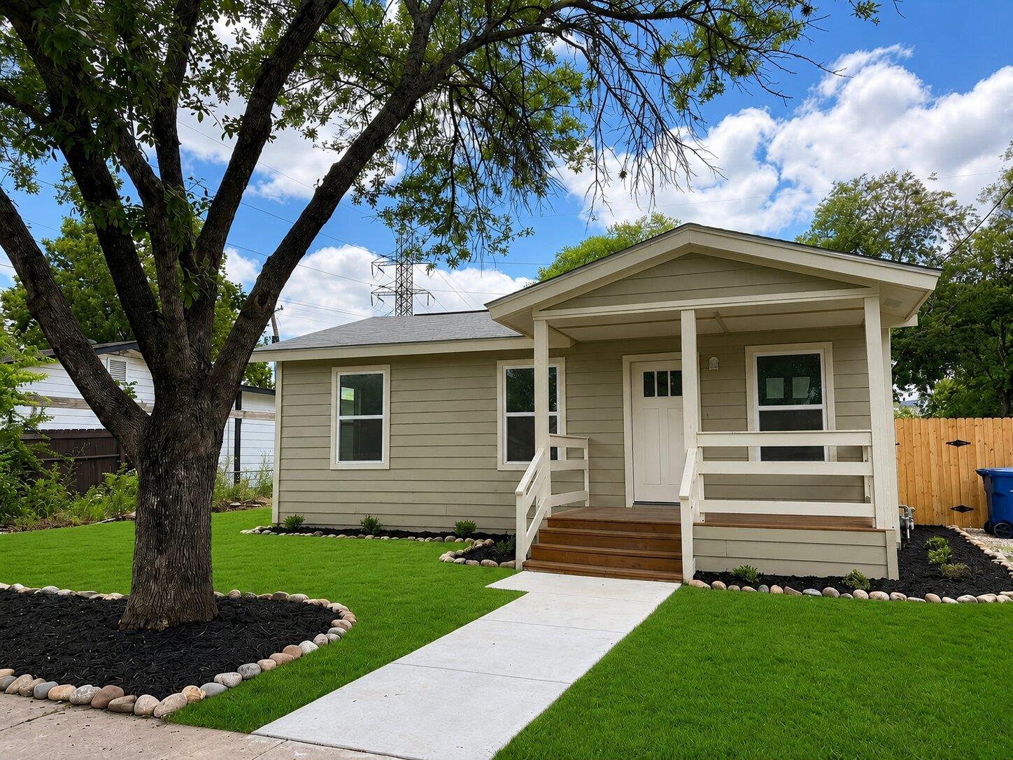 A welcoming covered porch and fresh landscaping e