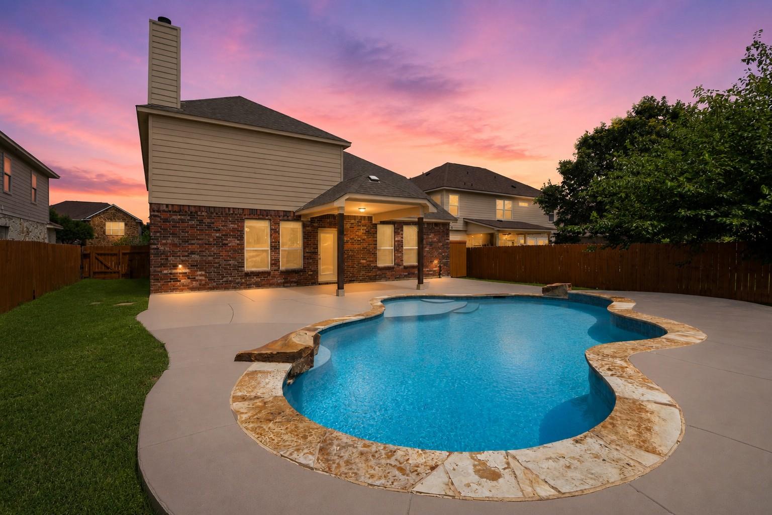 A private backyard oasis features a free-form poo