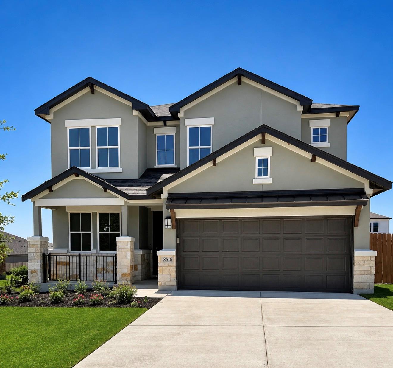 A striking gray stucco home with dark roof accent