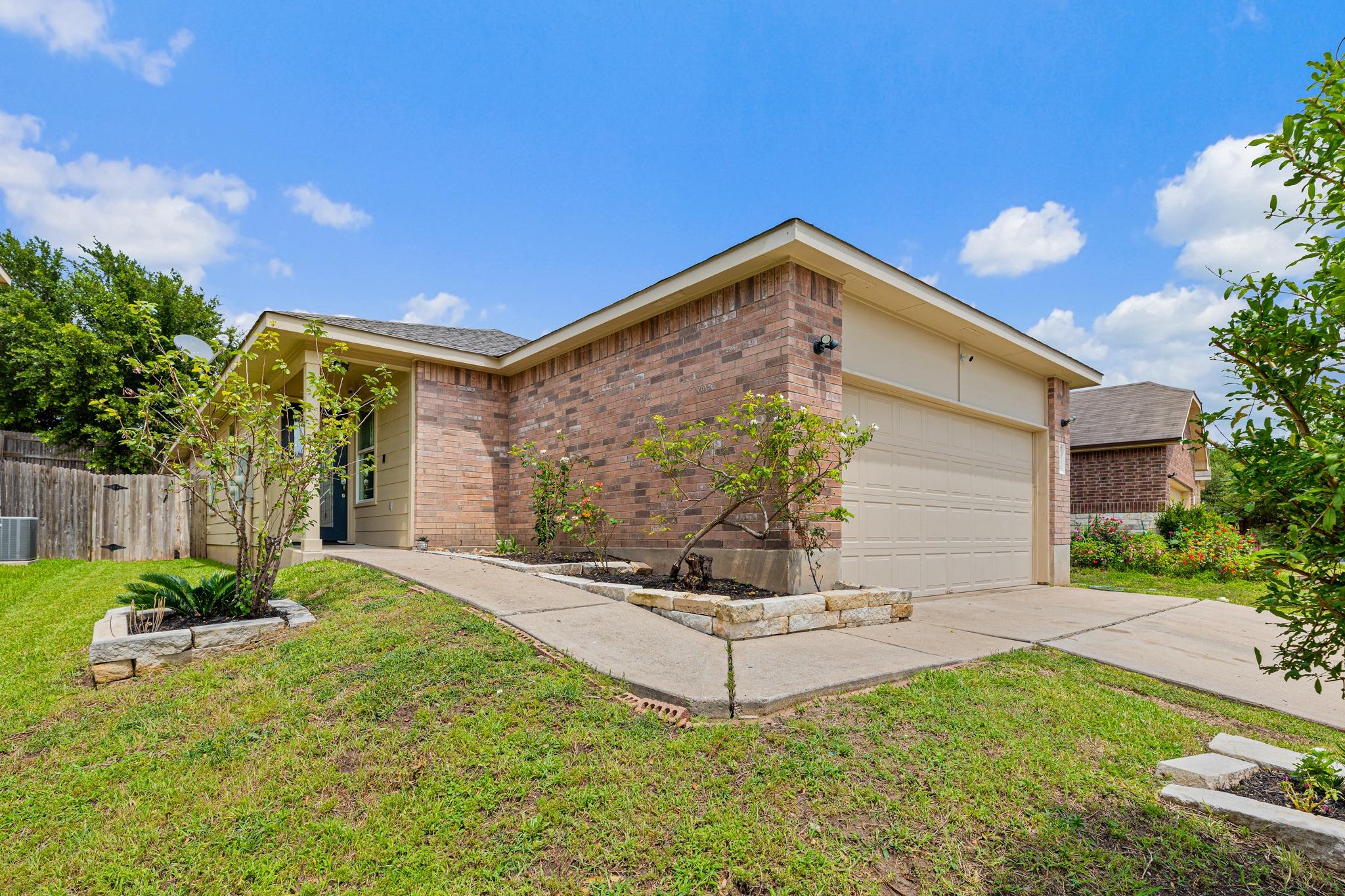 A welcoming brick facade with a neatly landscaped