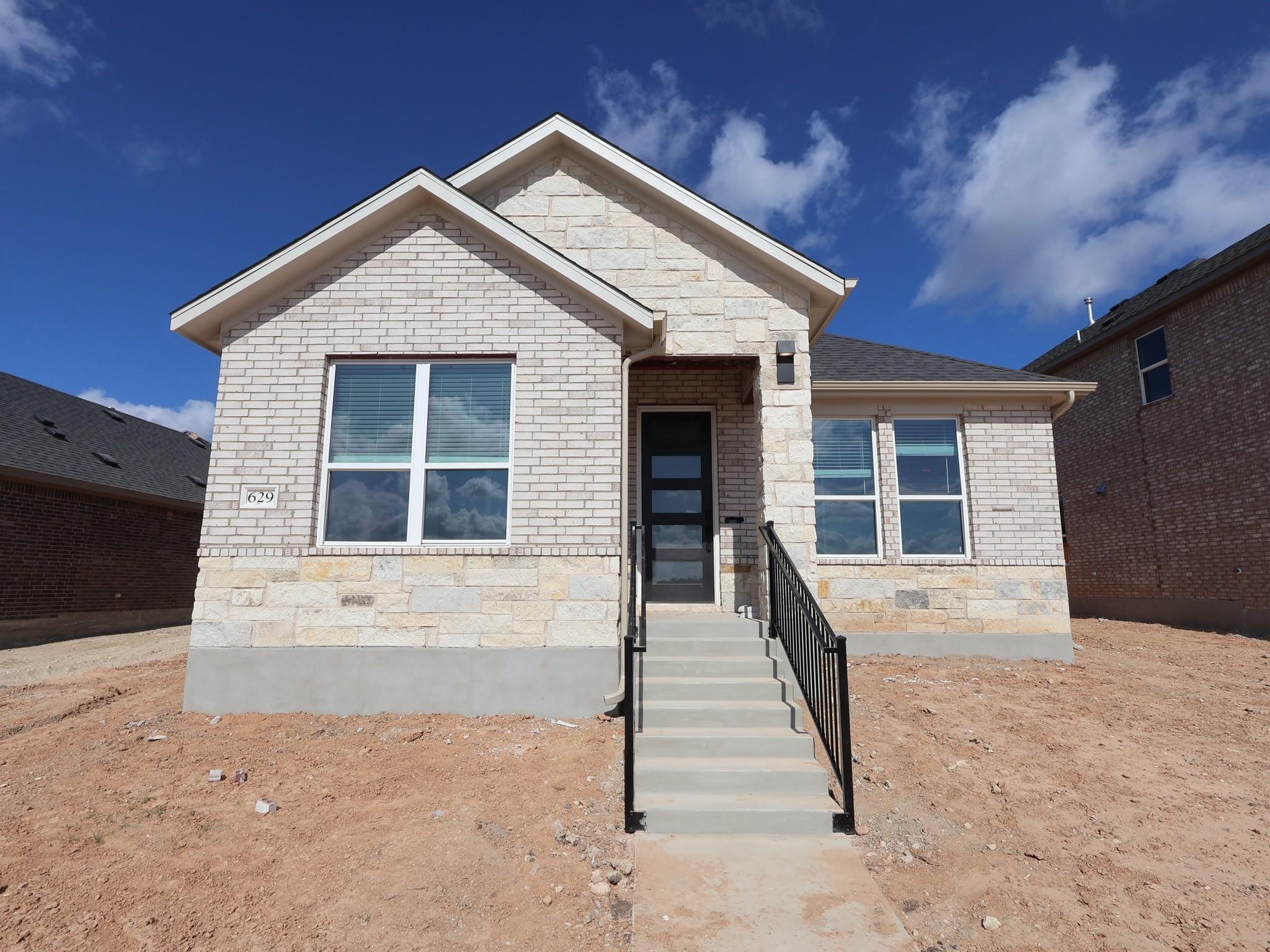 A classic brick and stone facade defines this new