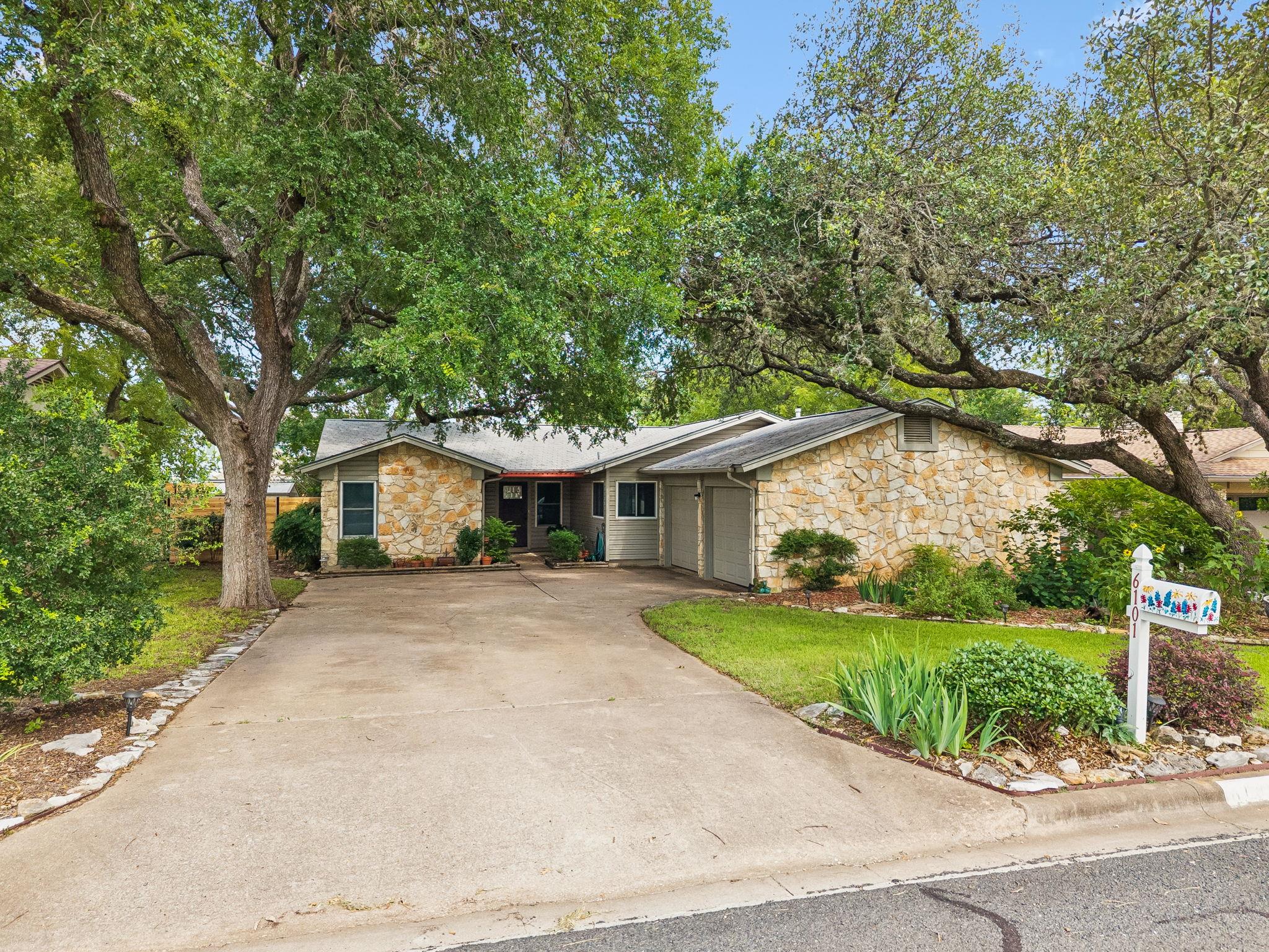 Mature trees shade this charming residence with n