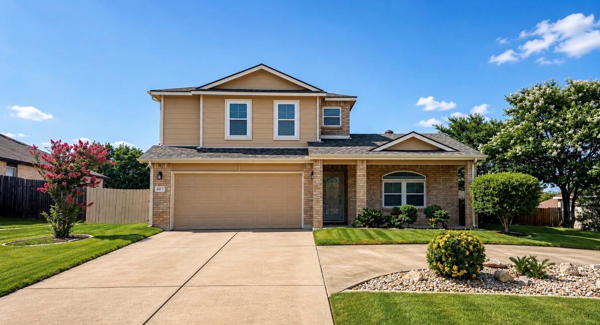 A well-maintained facade with a two-car garage an