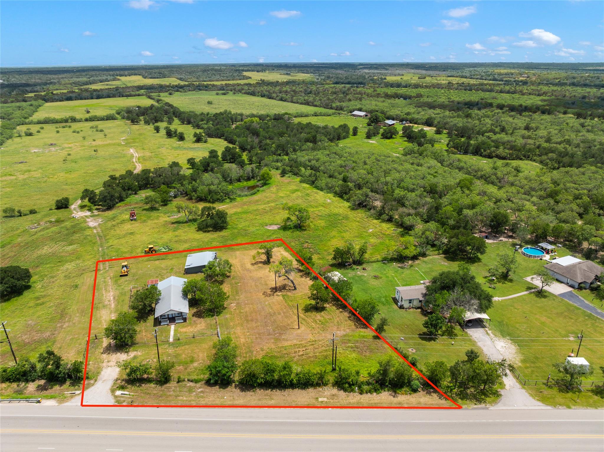 An aerial perspective reveals a secluded ranch-st