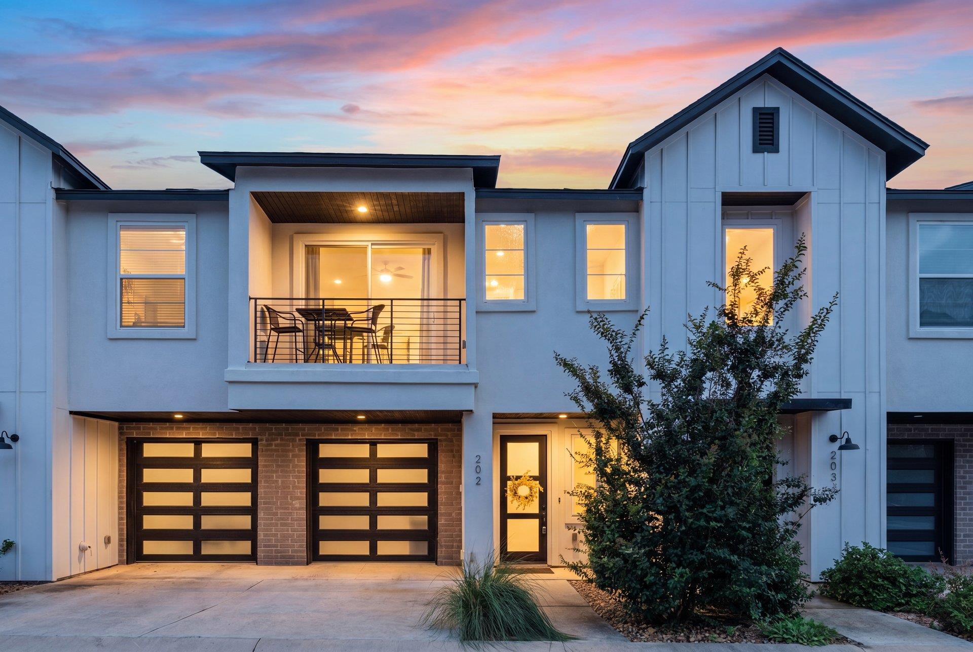 A contemporary townhome facade featuring an invit