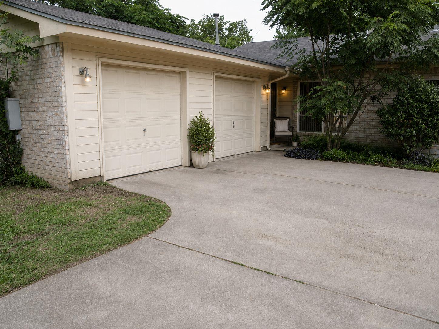A wide concrete driveway leads to a classic two-c