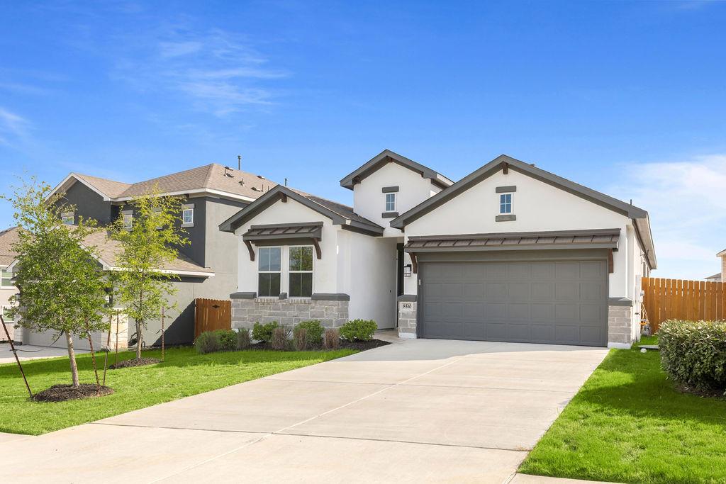 A well-maintained lawn and extended driveway welc