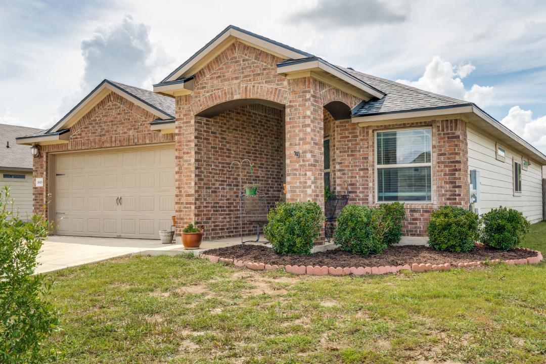 A well-kept front yard complements this brick-fro