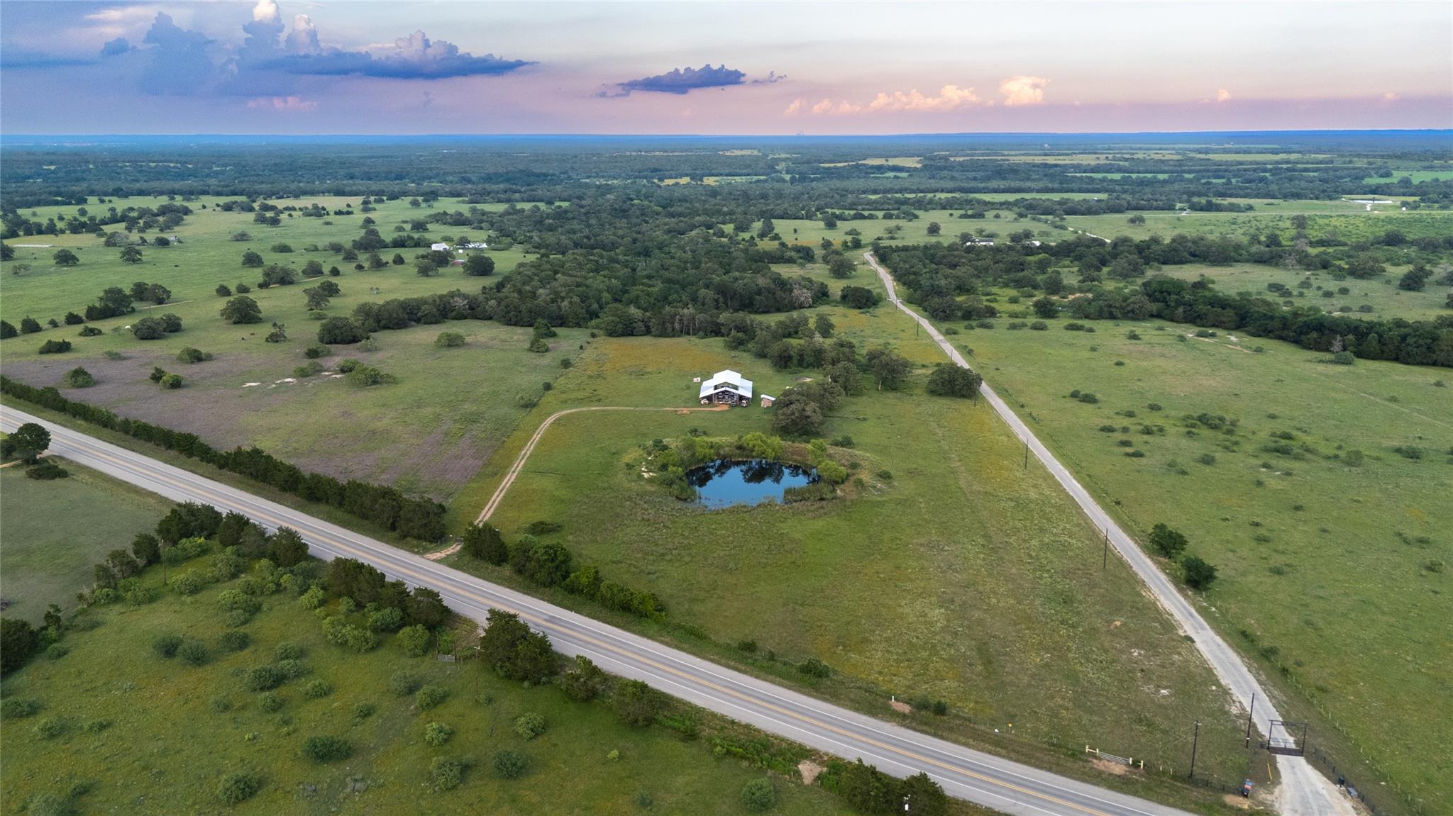 An aerial perspective reveals a private pond alon